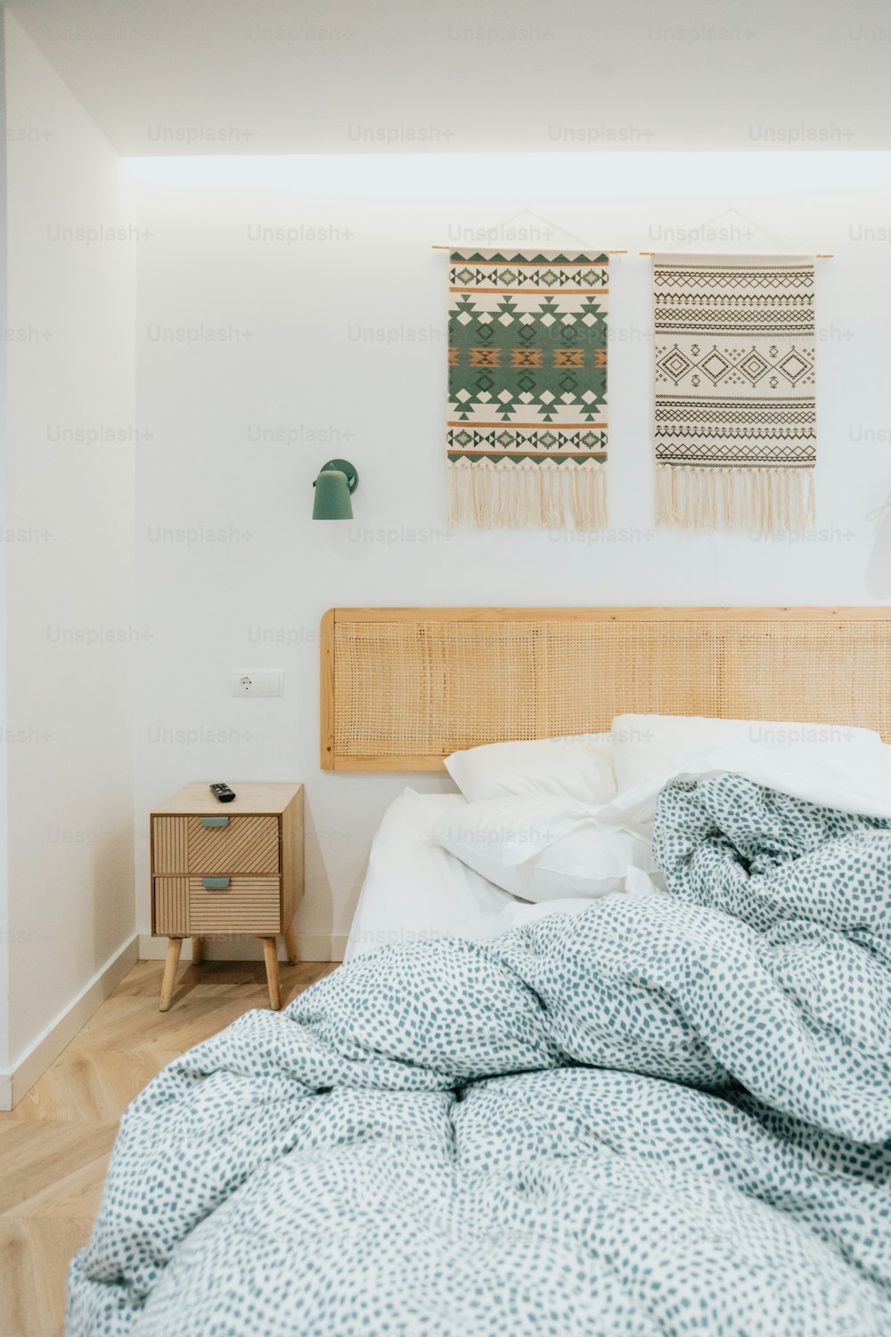 a bed with a wooden headboard and a blanket on top of it