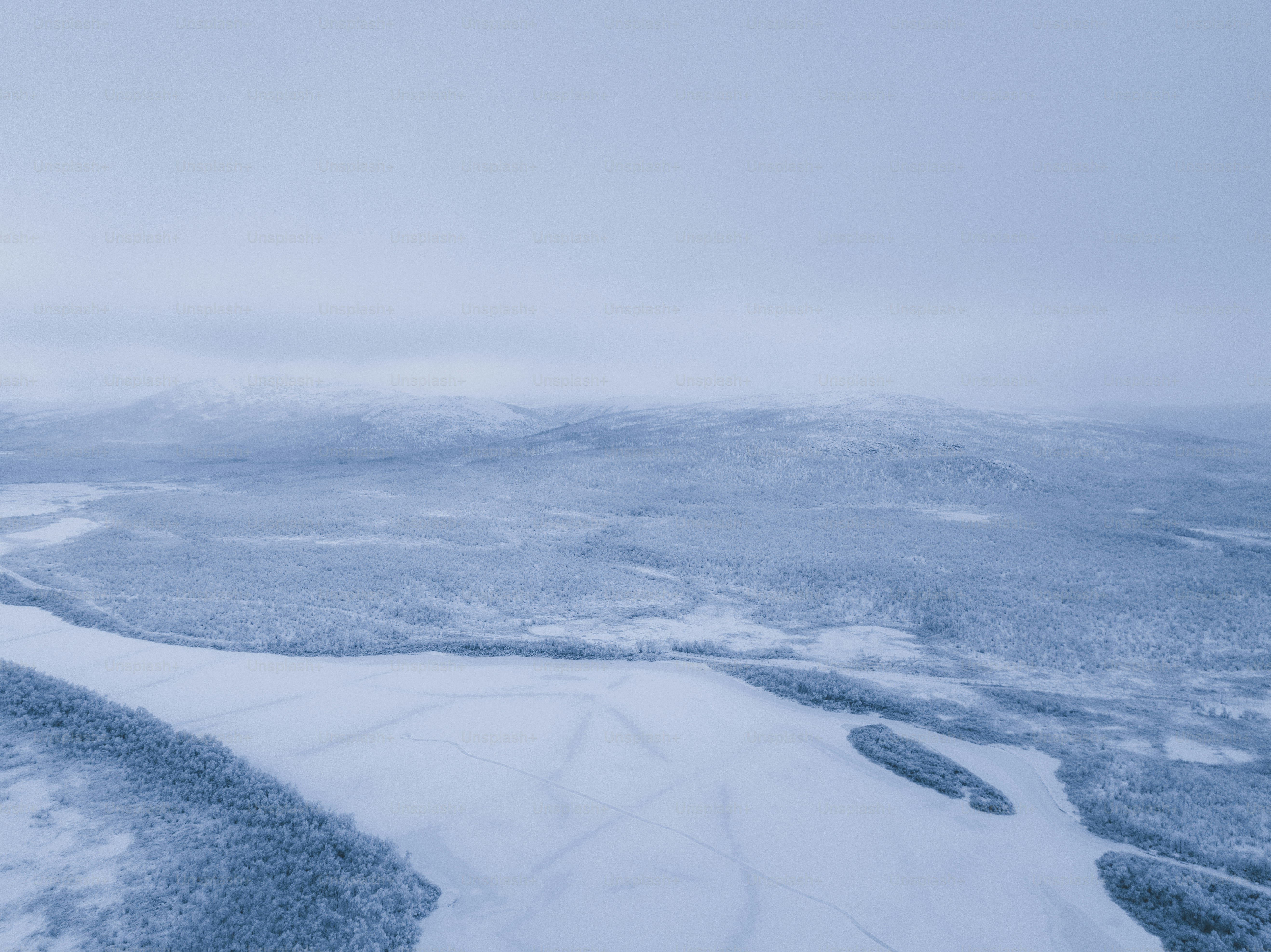 an aerial view of a snow covered landscape