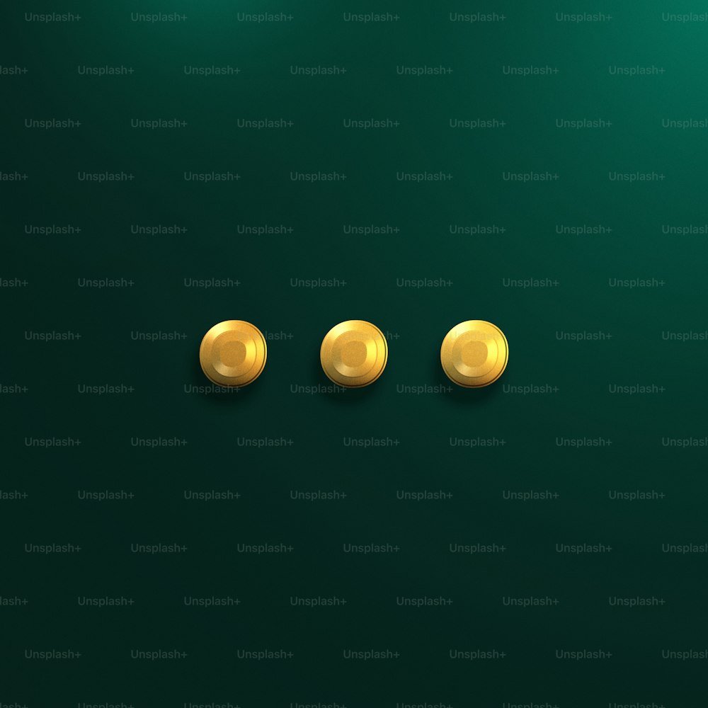 three gold buttons on a green background
