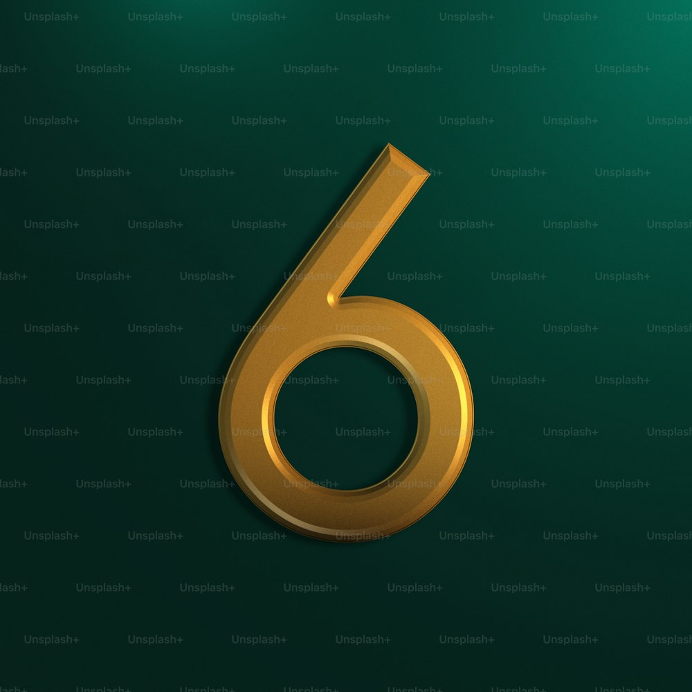 a gold number six on a green background