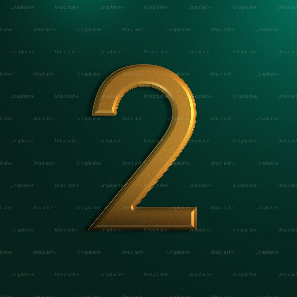 a gold number two on a green background