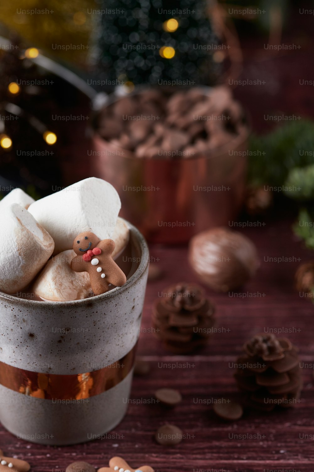 a cup filled with marshmallows and a teddy bear