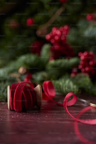 a close up of a red ribbon on a table