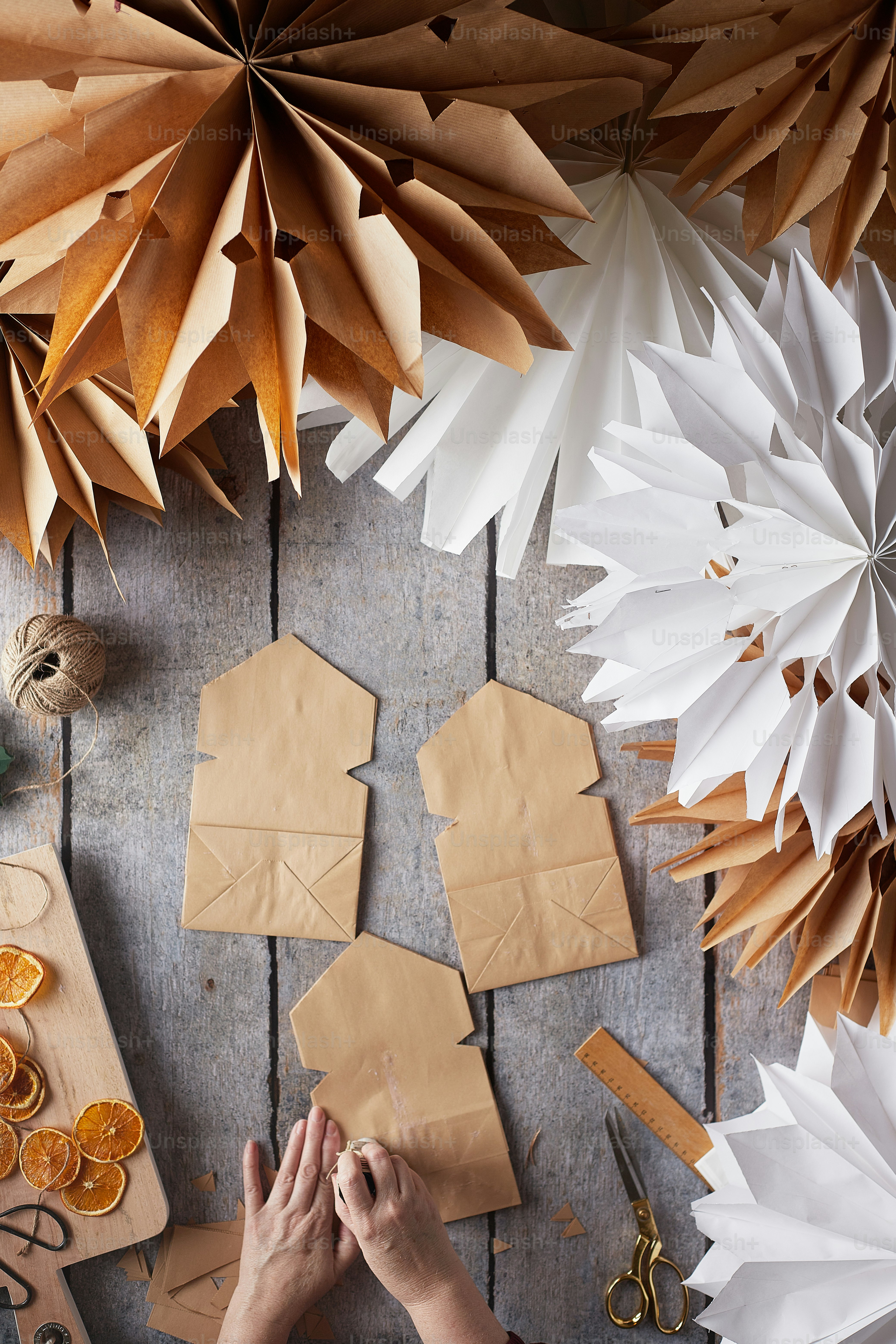a person cutting paper with scissors and a pair of scissors