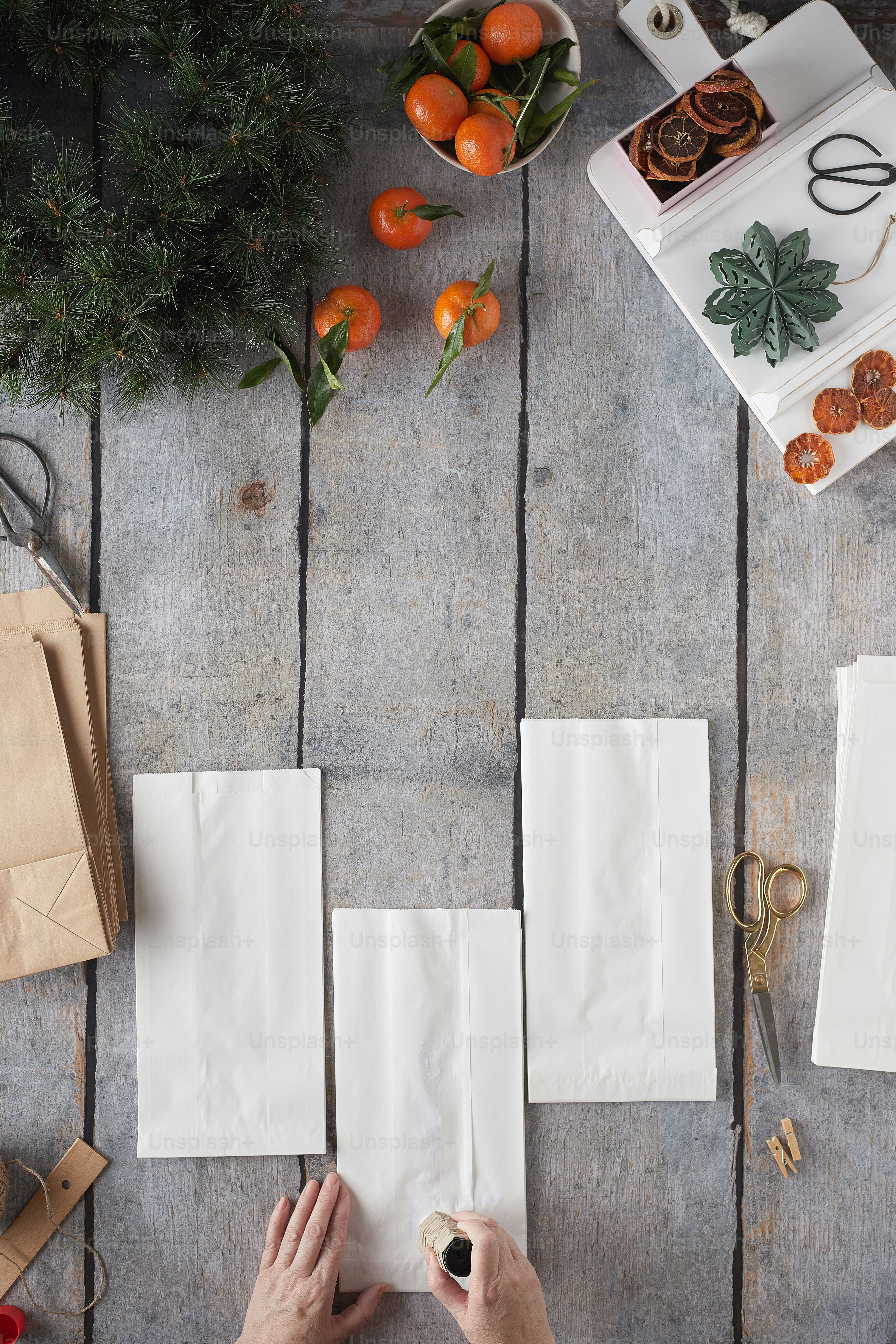 a person is making paper flowers on a table