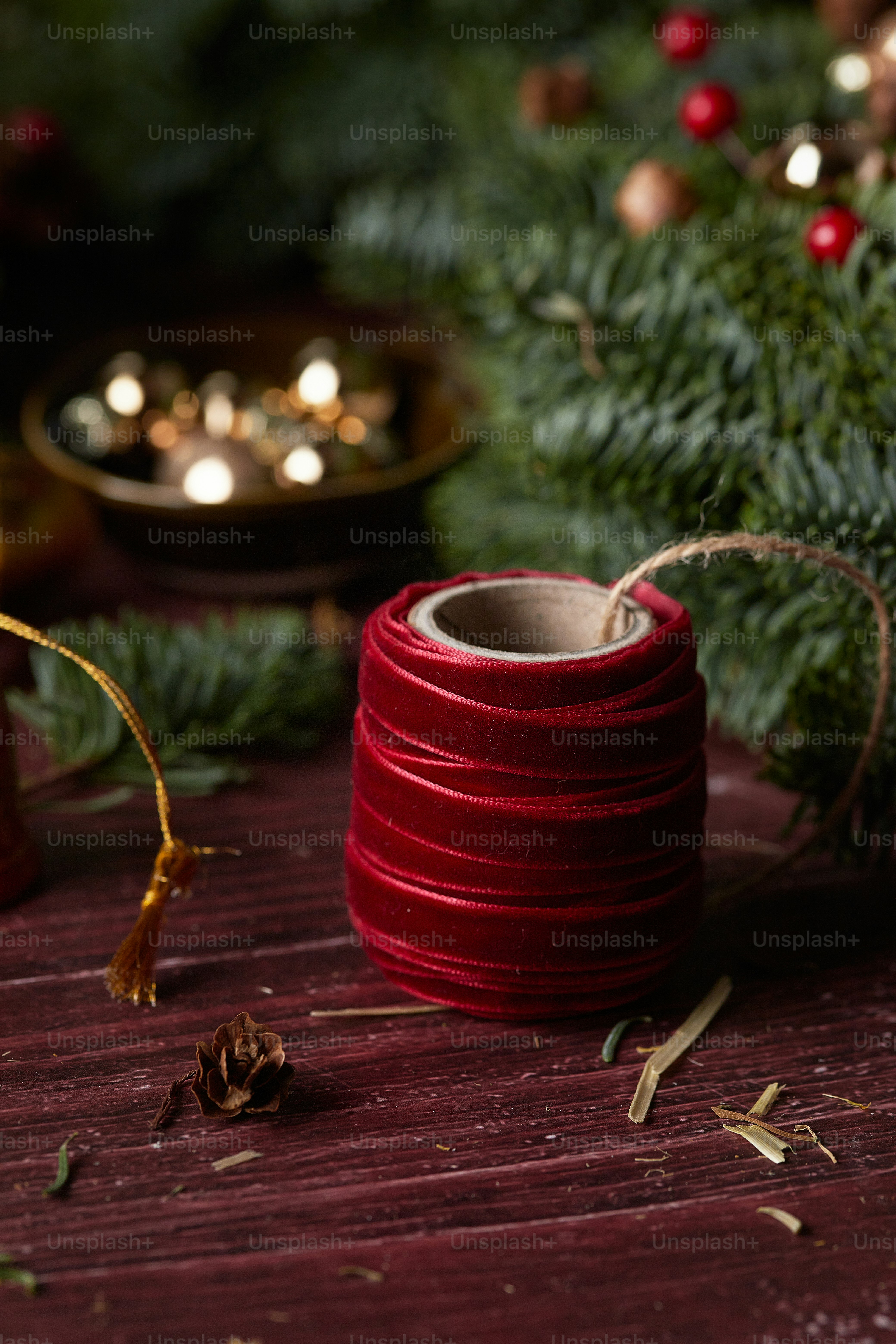 a red candle next to a tree