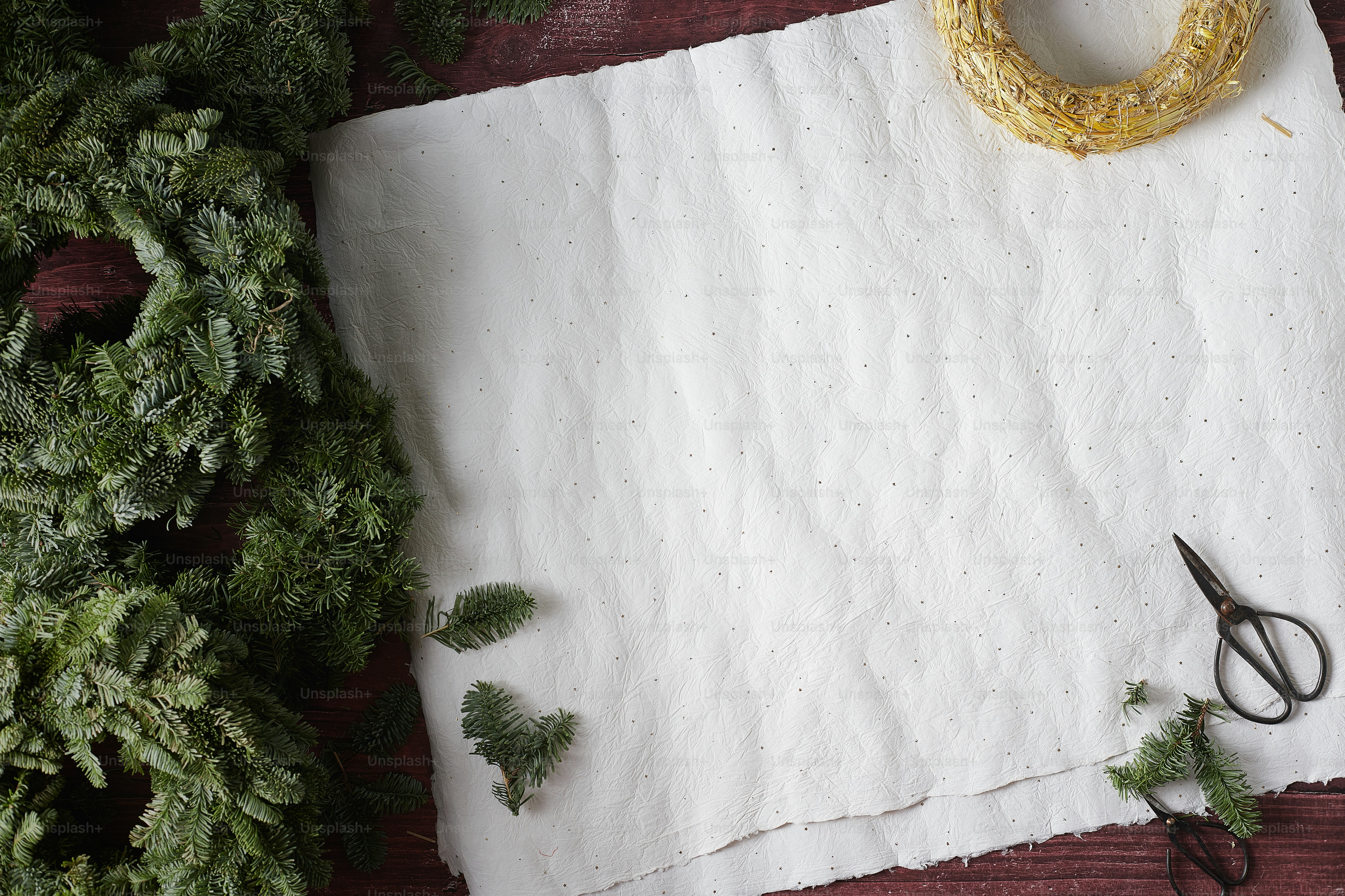 a white wall with a gold cross and a pair of sunglasses