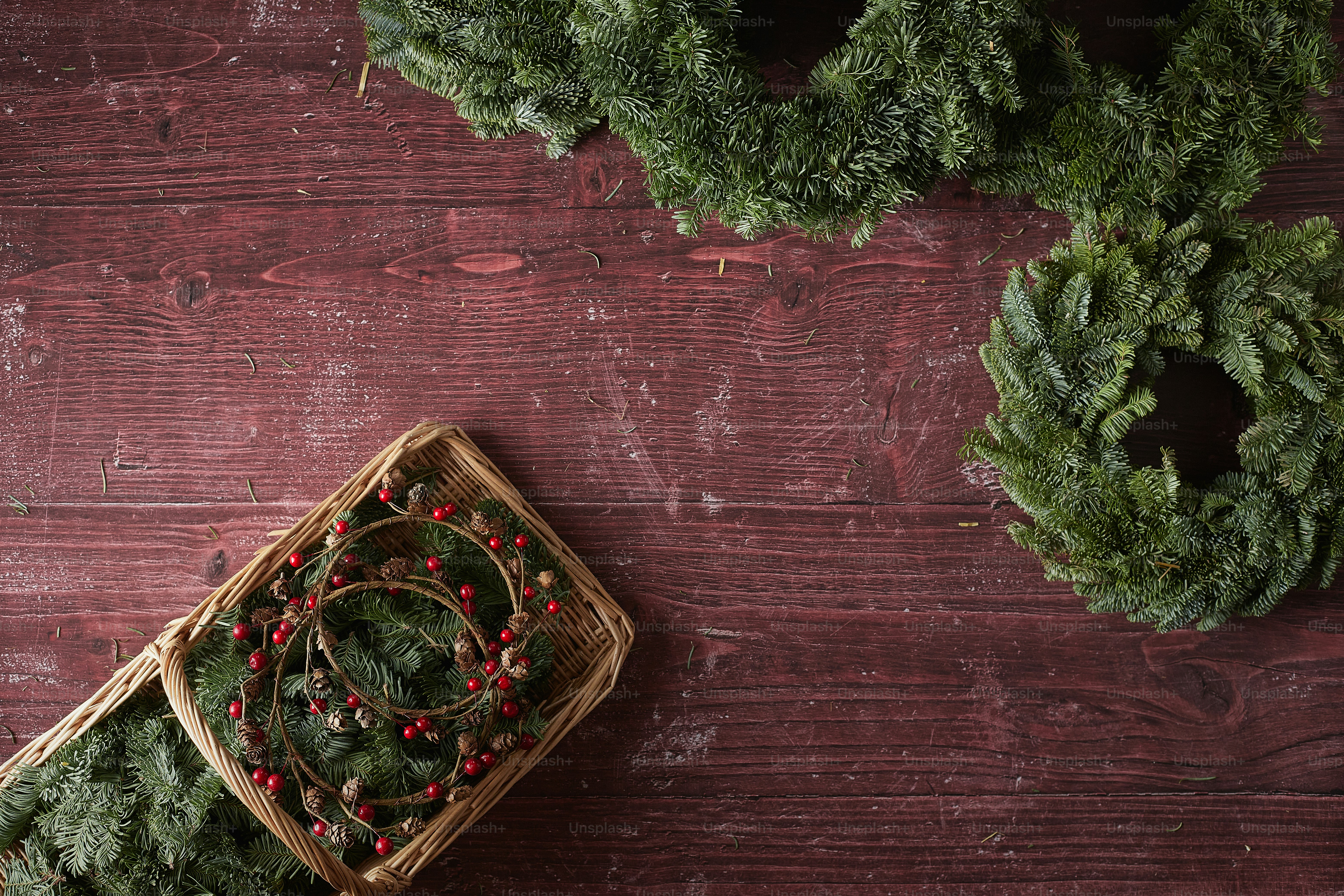 a wooden deck with a basket and plants on it