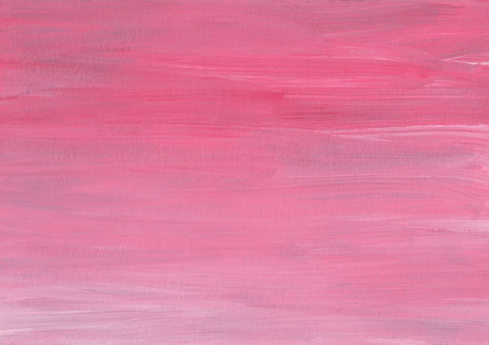 a pink surface with a dark background