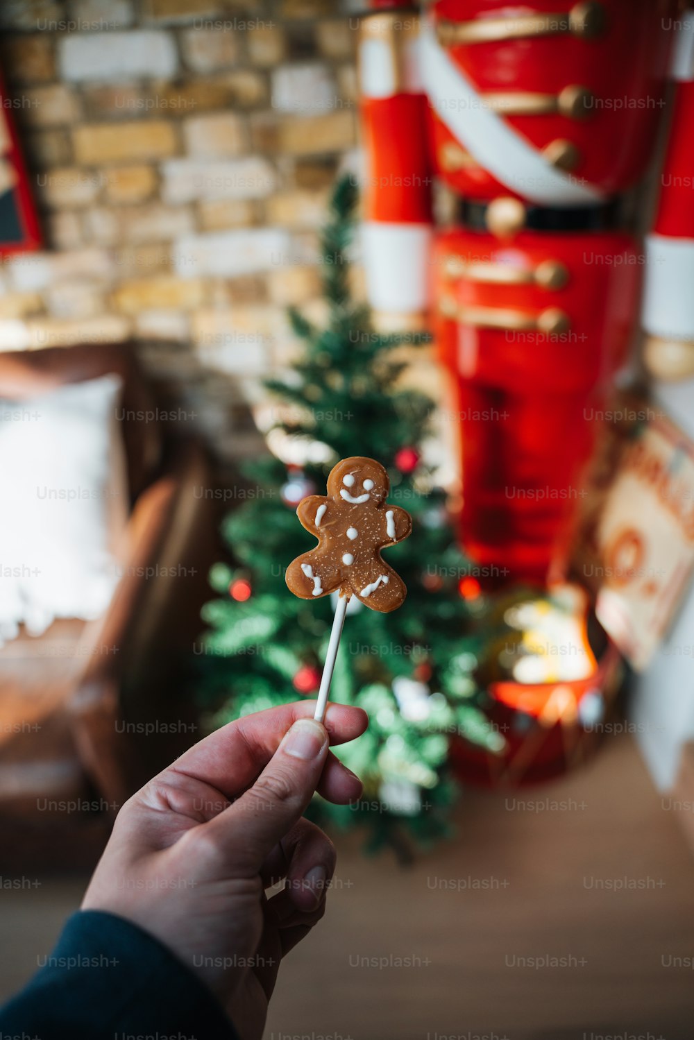 a hand holding a small christmas tree