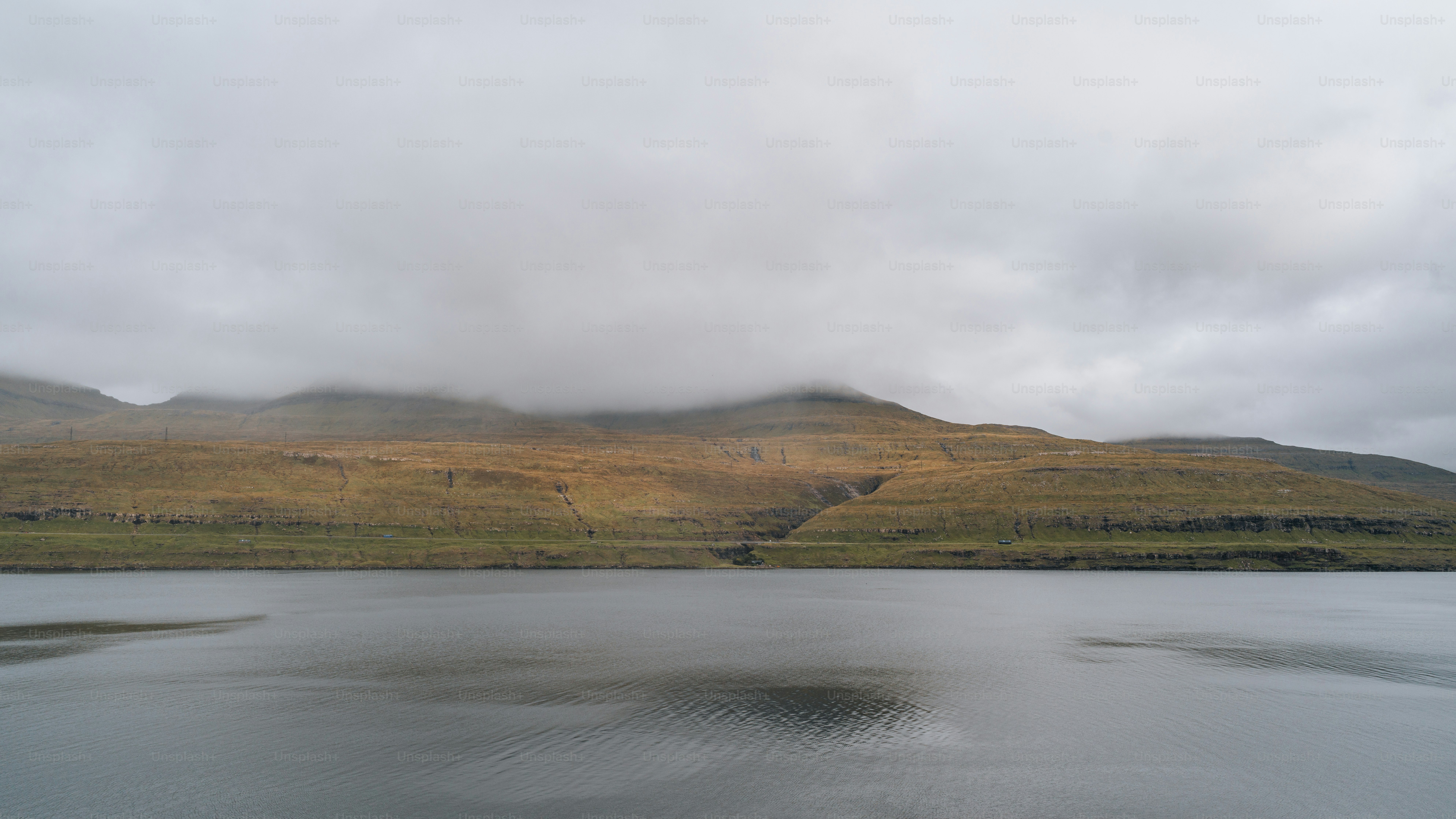 a body of water with hills in the background