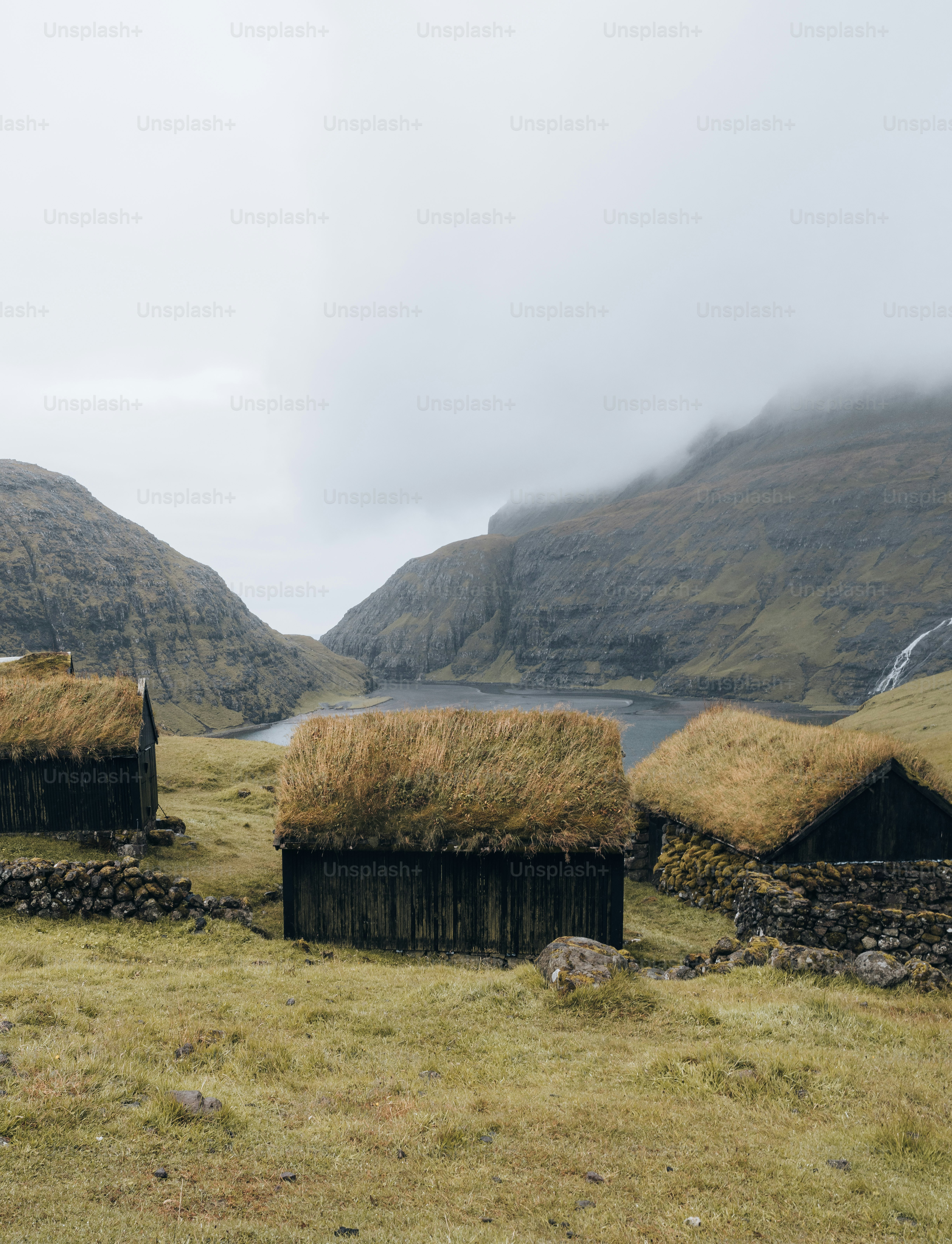 a group of huts in a field