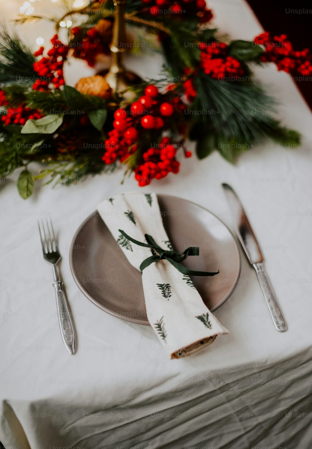 a table with a silverware and a decorated tree