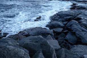 a rocky shoreline with waves crashing