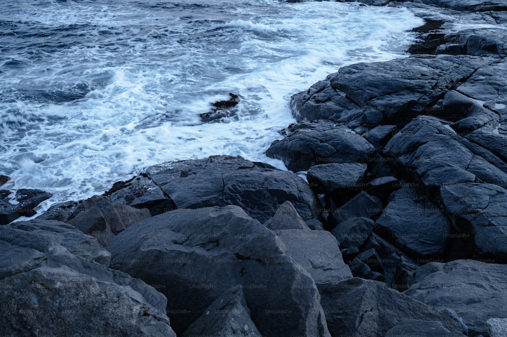 a rocky shoreline with waves crashing