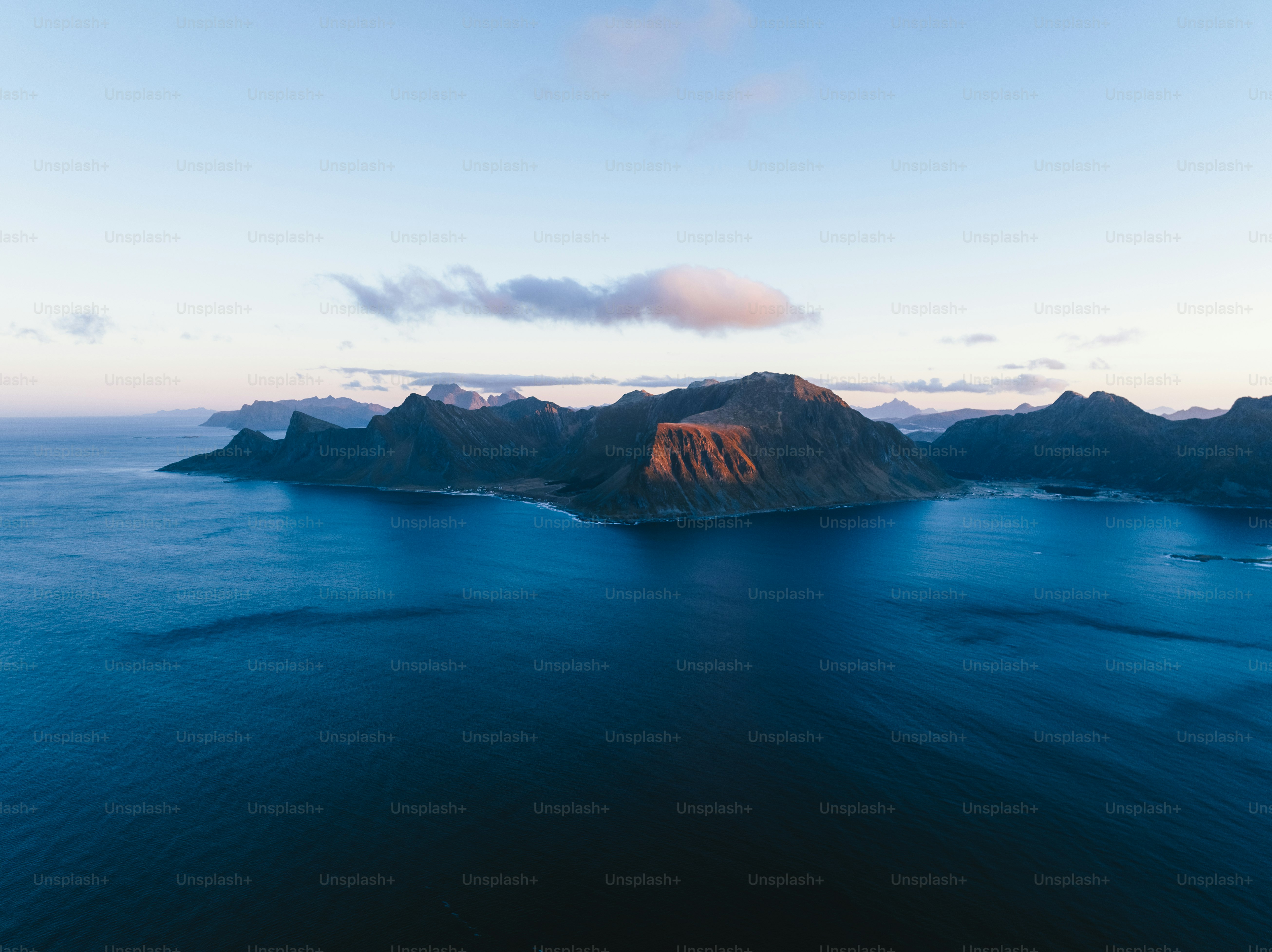 a body of water with a mountain in the distance
