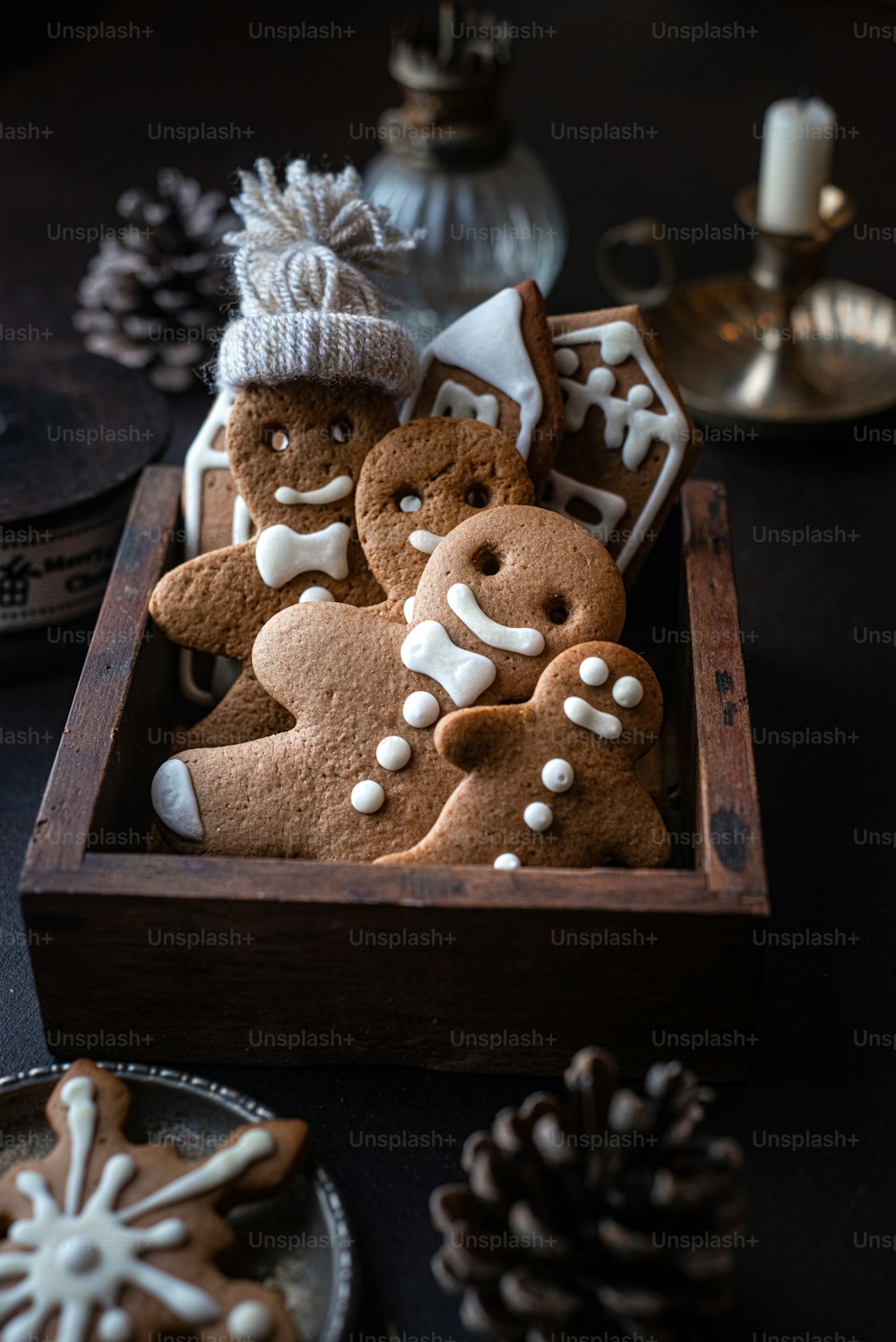 a gingerbread man with a hat and a bow on a wooden table