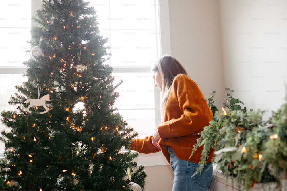 a person looking at a christmas tree