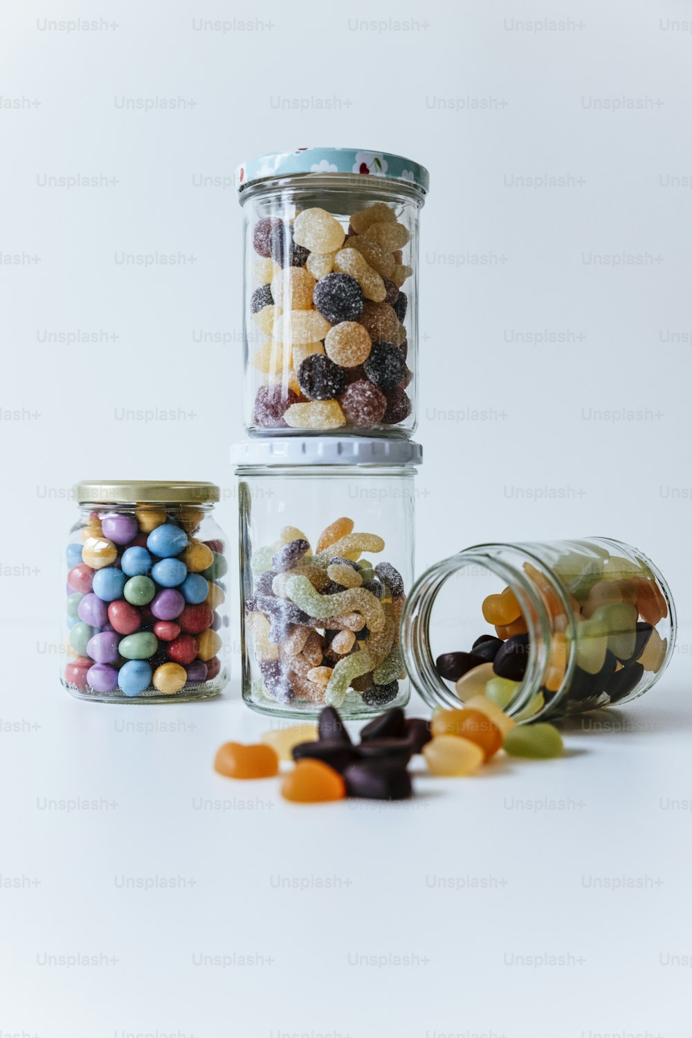 a group of glass jars with candy in them