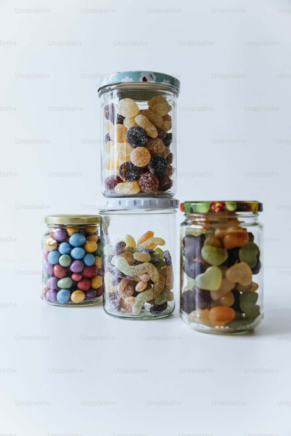 a group of glass jars with candy in them