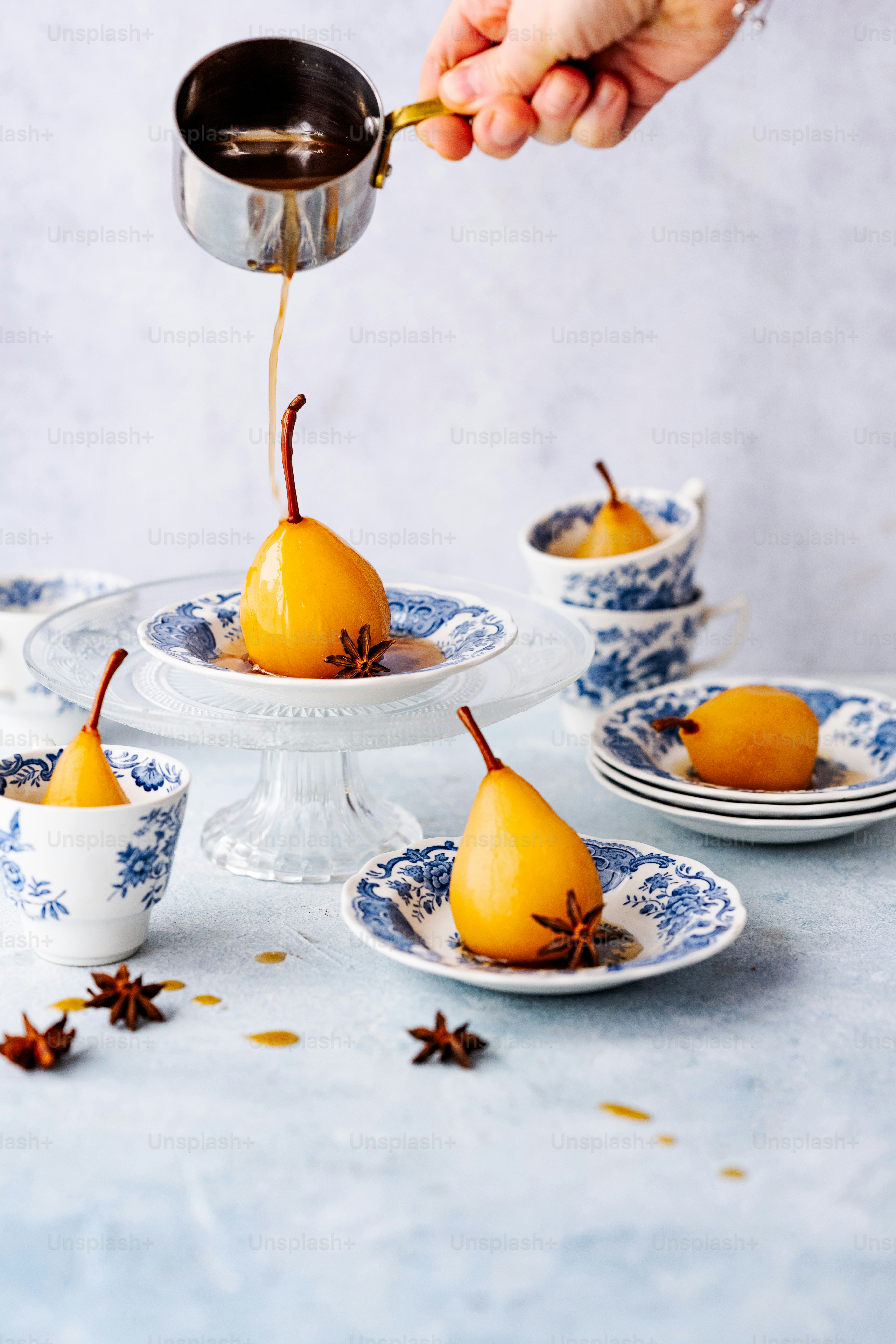 a person pouring tea into a teacup