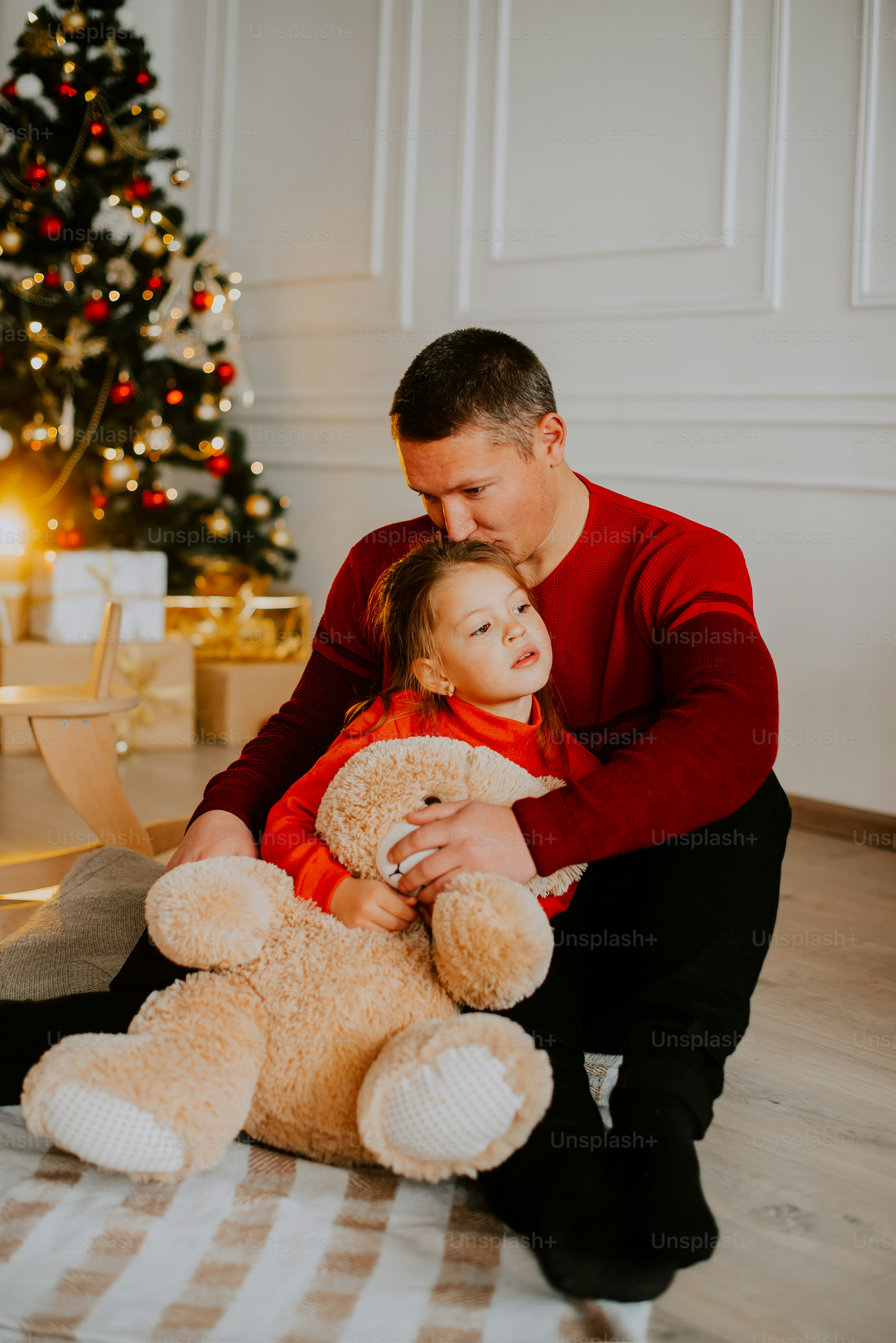 a man and a woman hugging a teddy bear