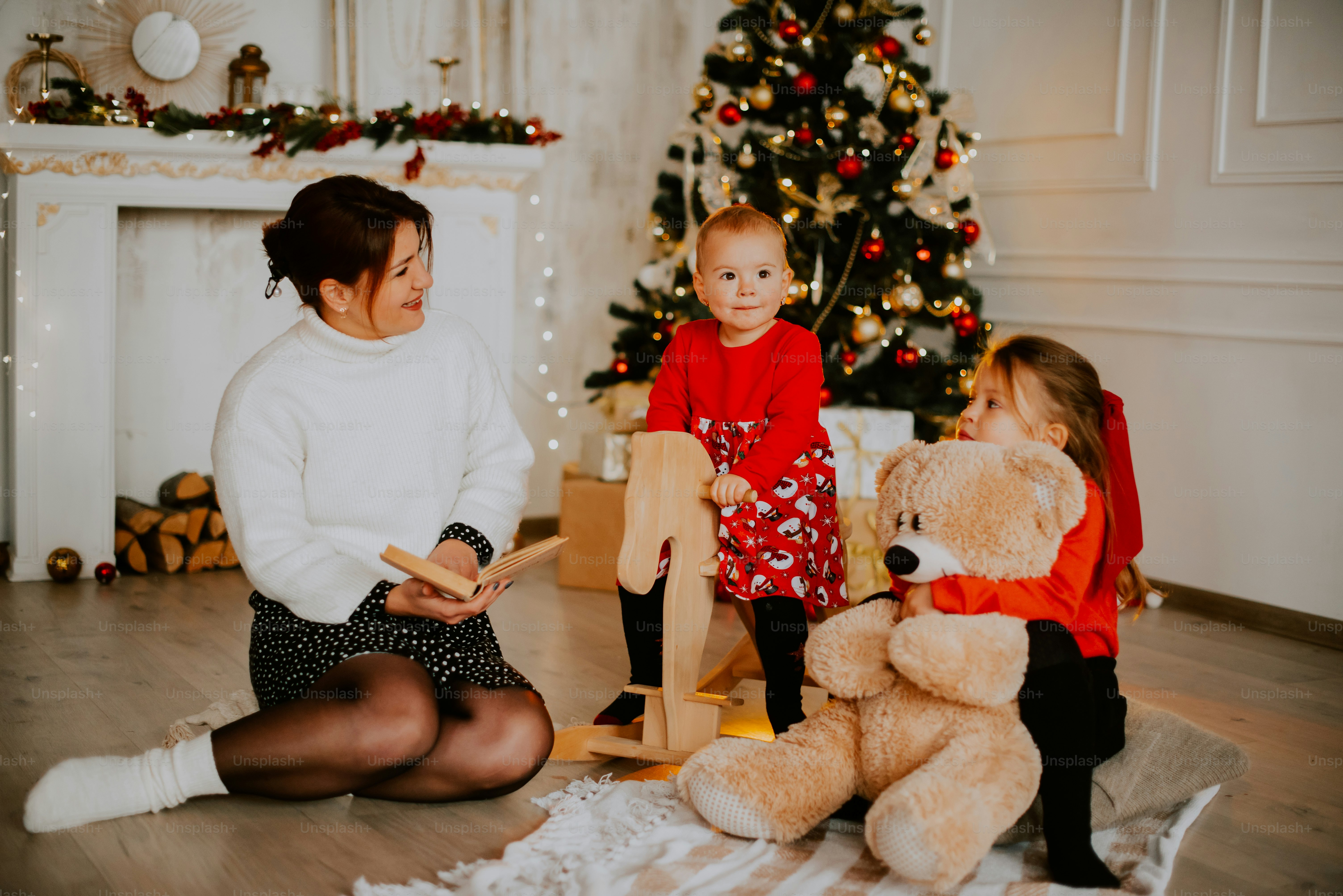 a man and woman with a child by a christmas tree
