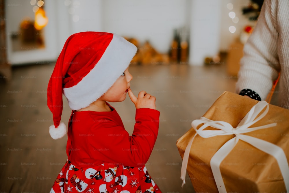 a baby wearing a santa hat