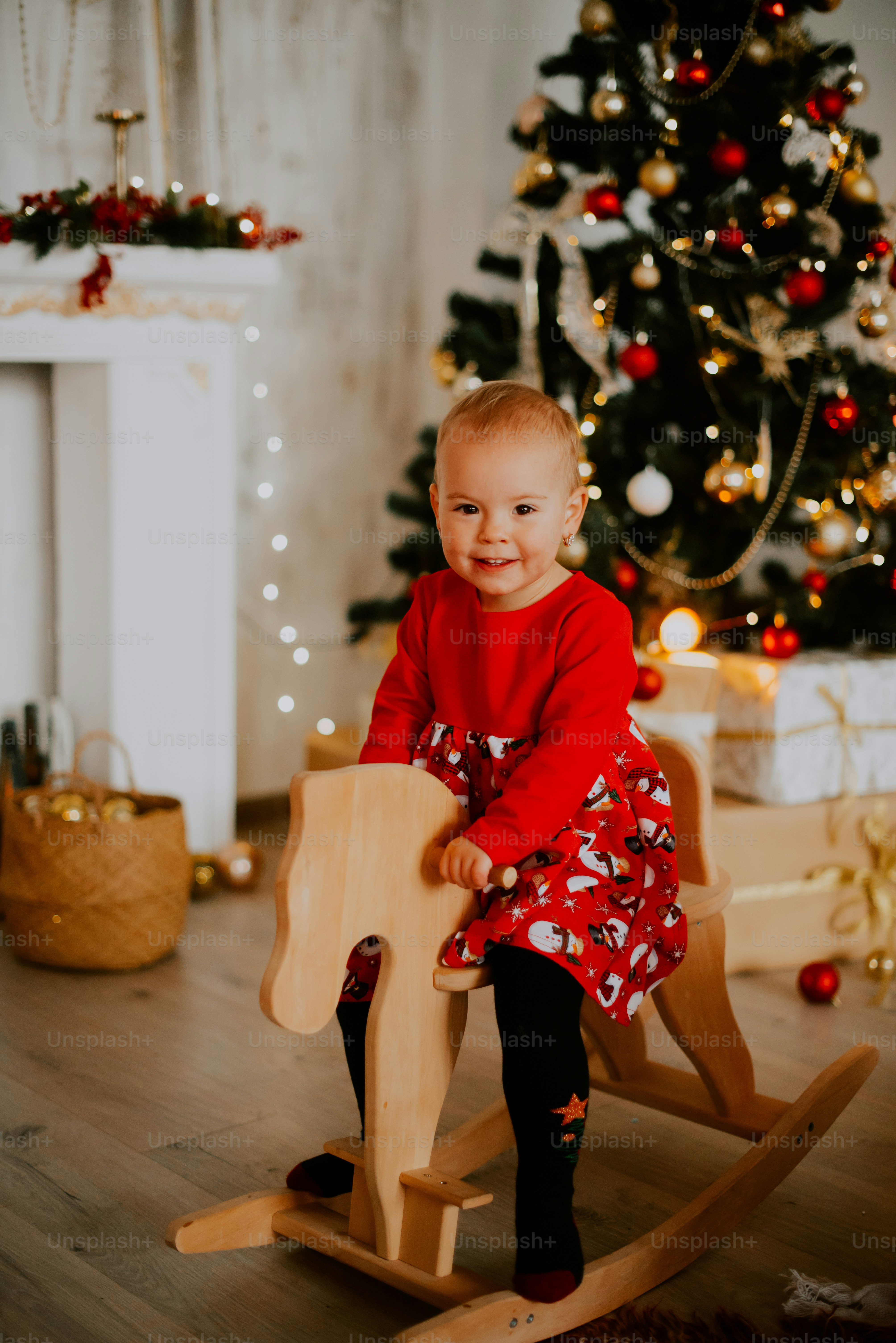 a child sitting on a rocking horse