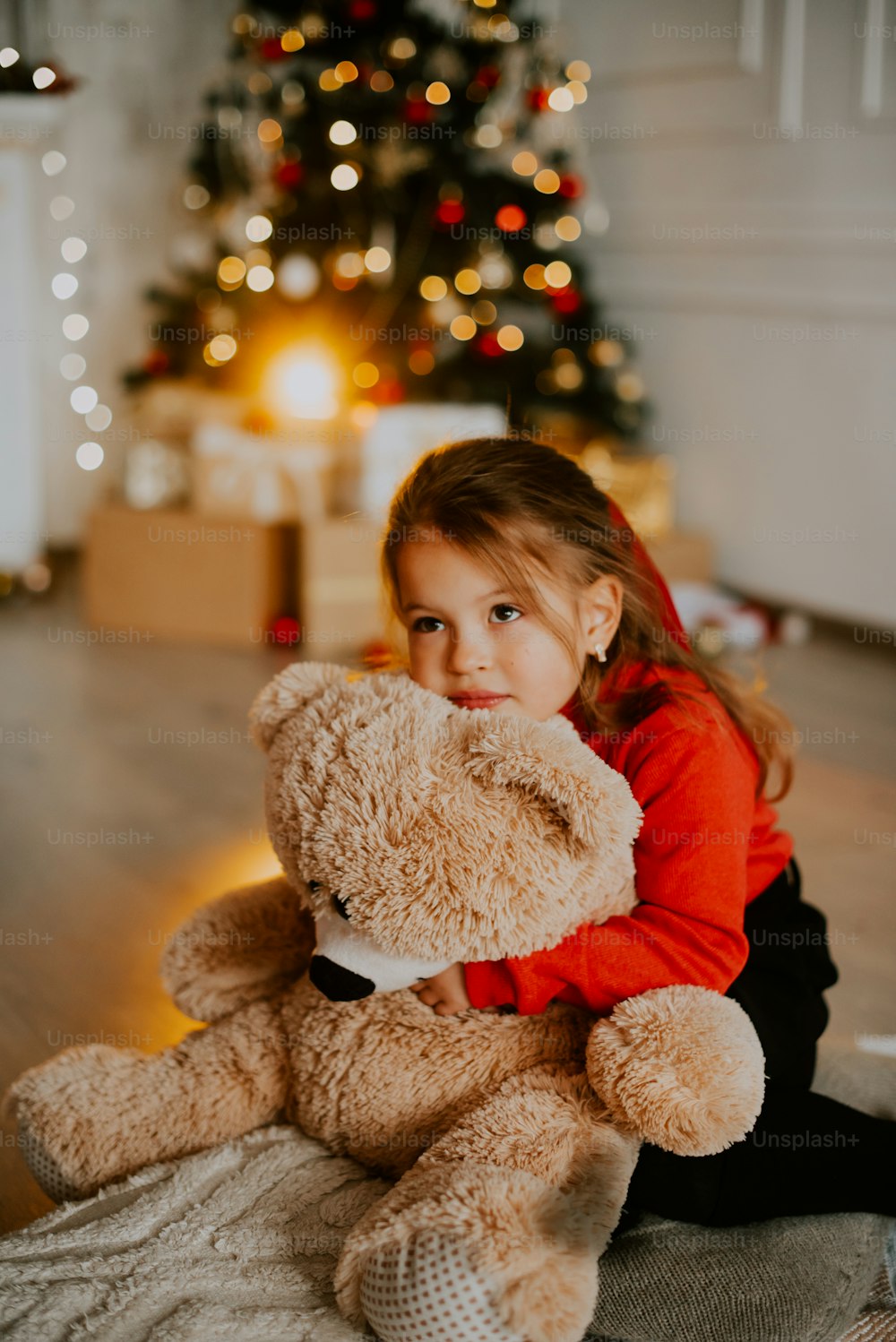 a girl holding a teddy bear