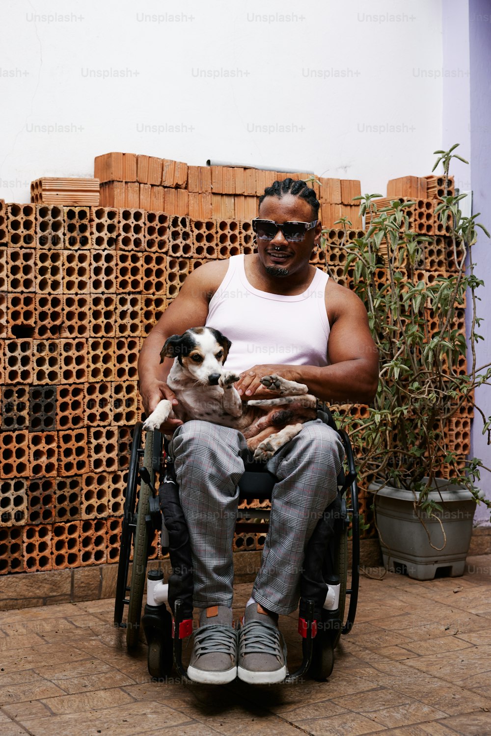 a man sitting in a wheelchair holding a dog