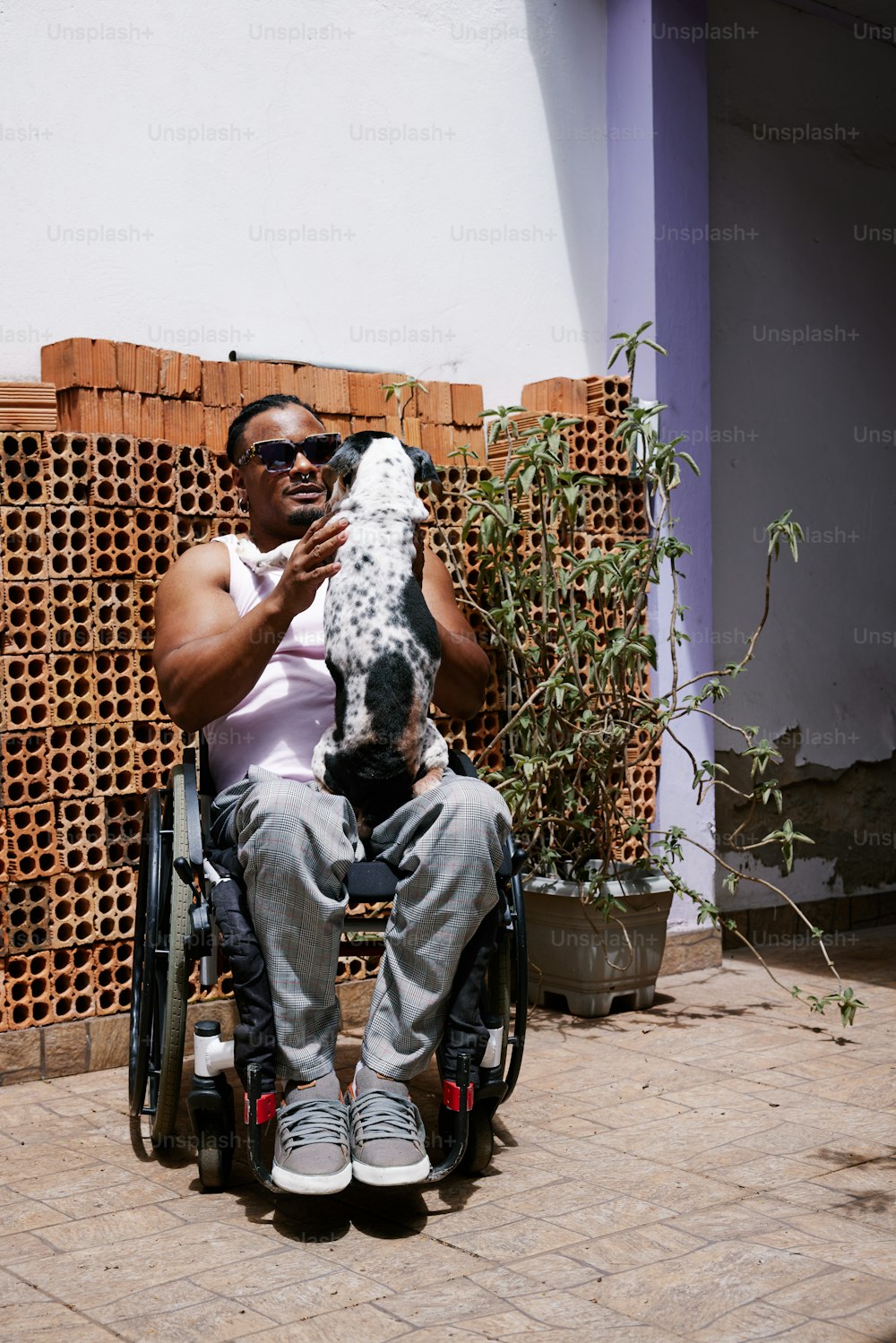 a person sitting in a wheelchair holding a fish