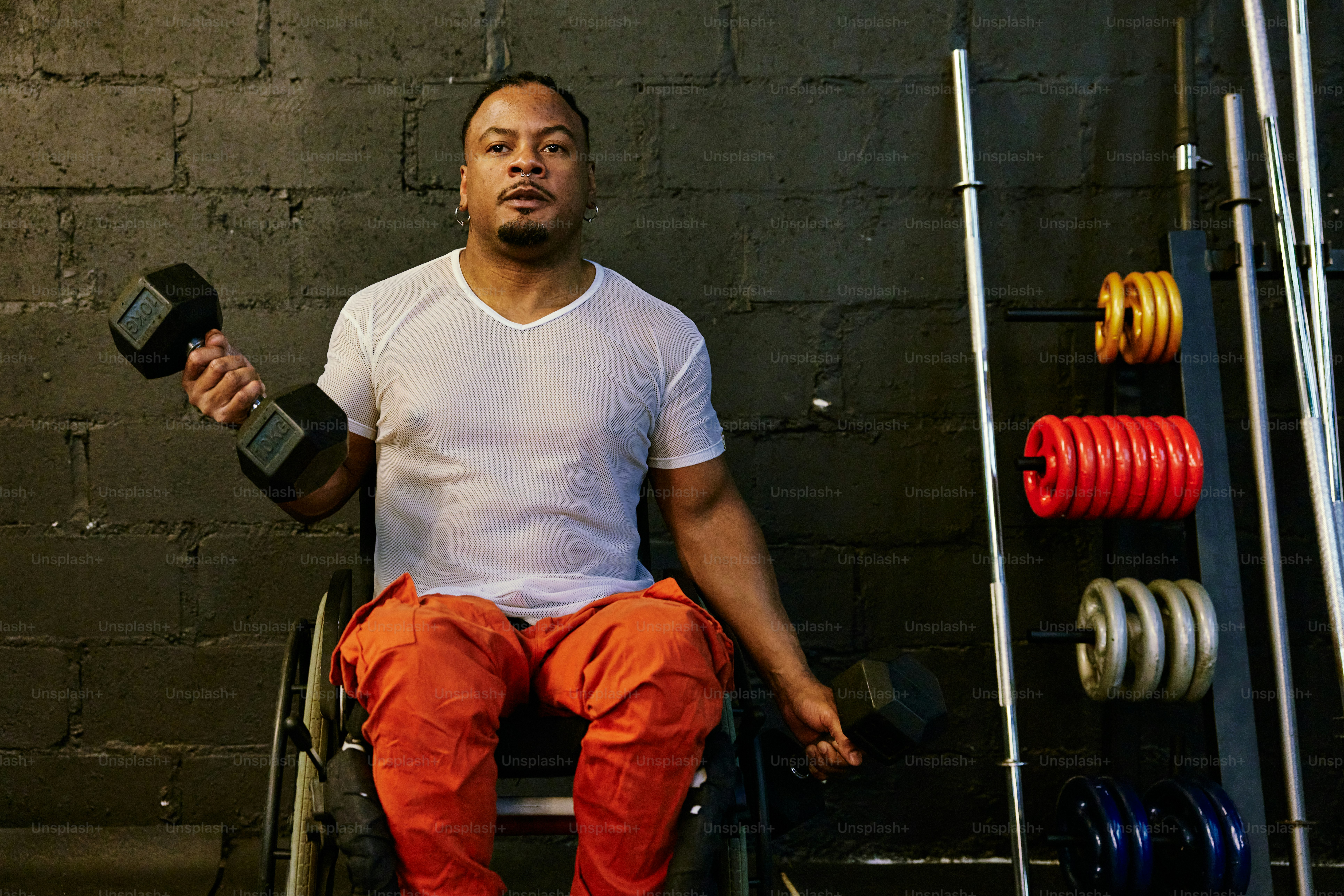 a man sitting on a chair holding a bottle of alcohol