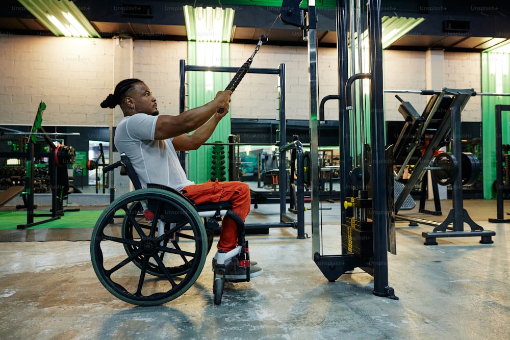 a man in a wheelchair working out in a gym
