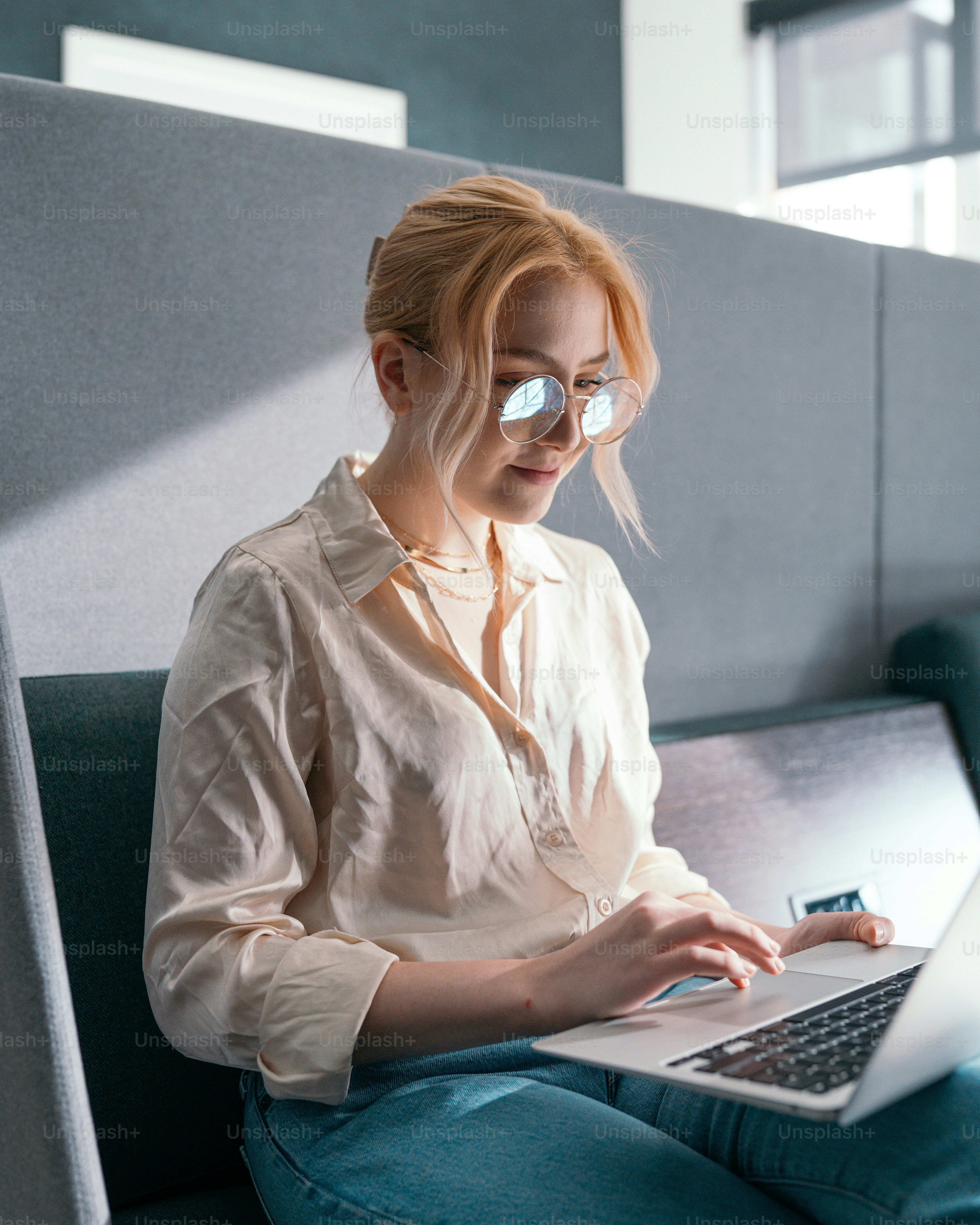a woman wearing a mask and using a laptop