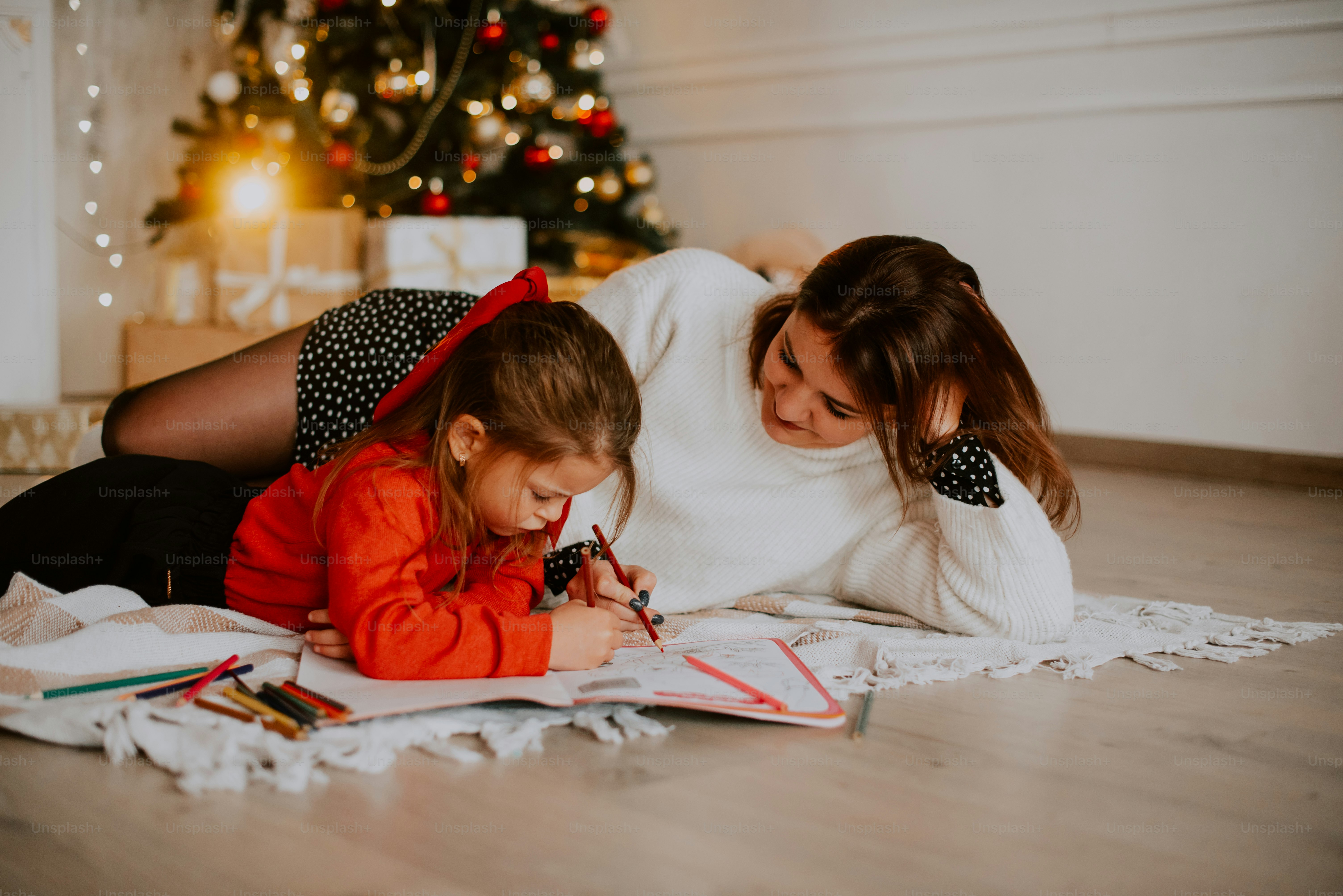 a person and a child writing on a book