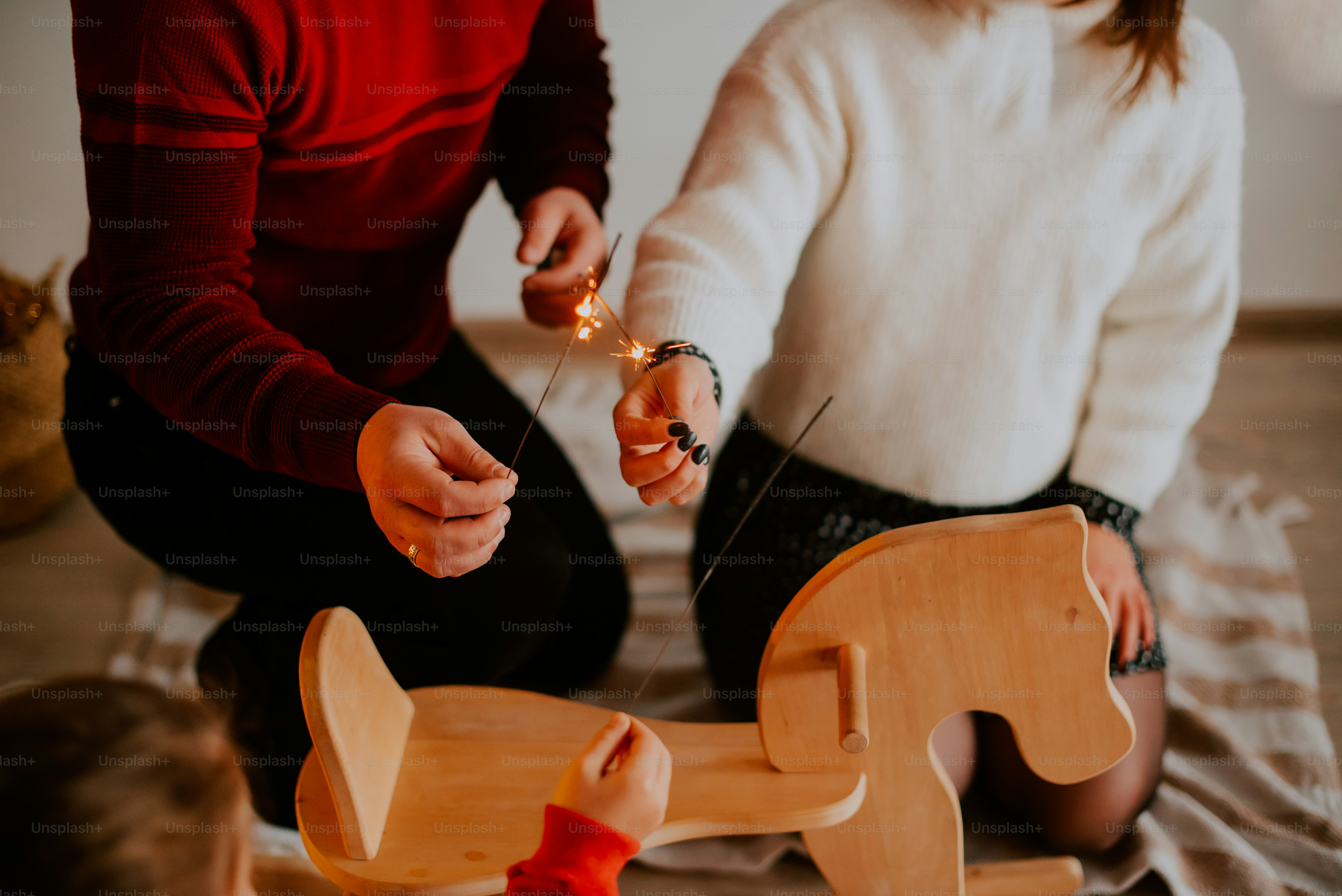 a pair of people cutting a wooden board