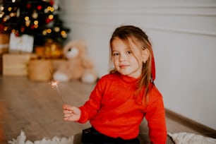 a girl holding a lit candle