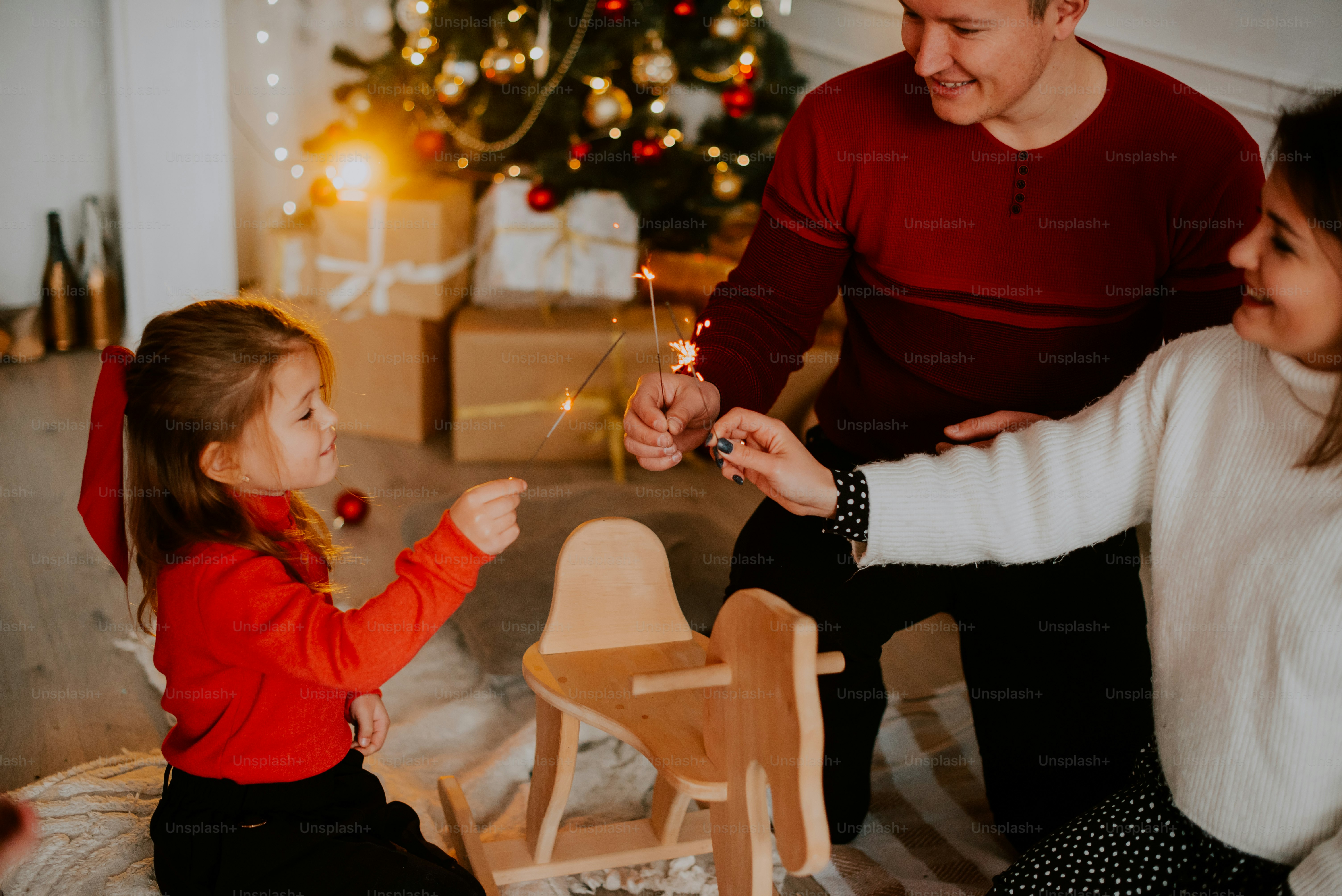 a man and a woman lighting a candle on a table