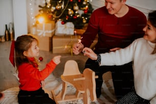 a man and a woman lighting a candle on a table