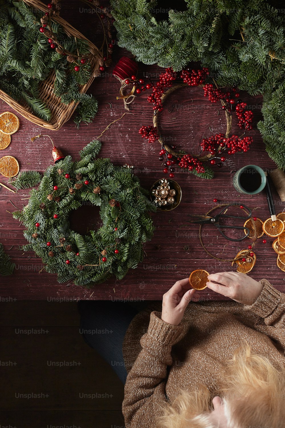 a person holding a cookie in front of a christmas tree