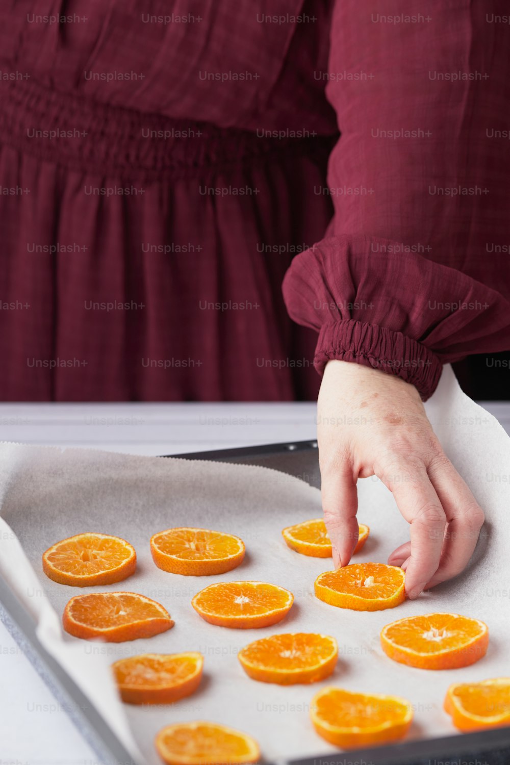 a person cutting oranges