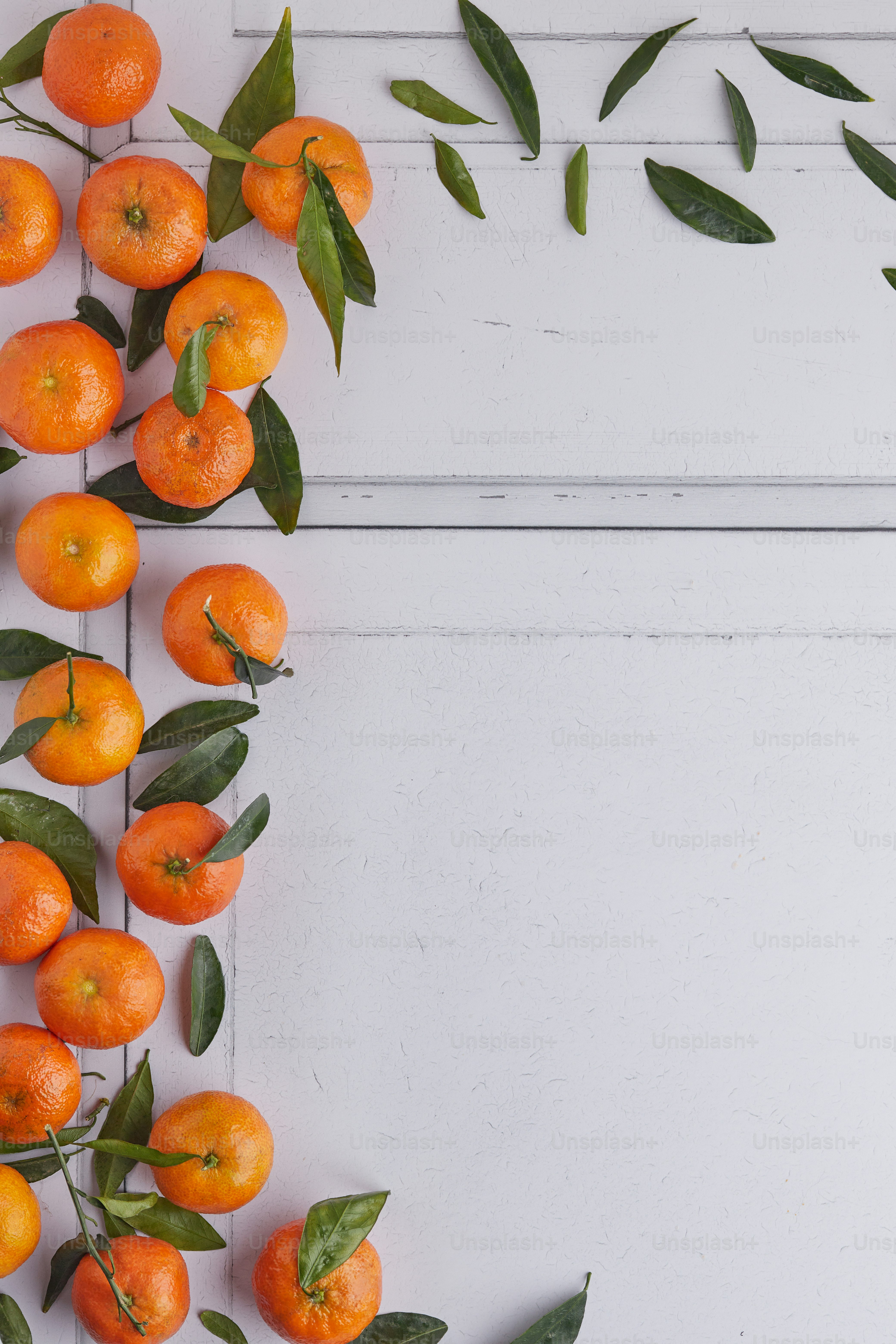 a bunch of oranges on a white surface