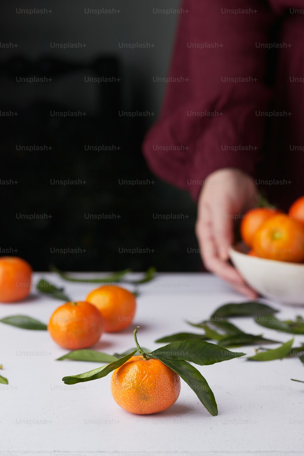 a person holding a small orange