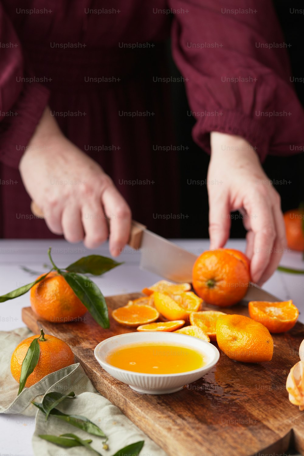 a person cutting oranges