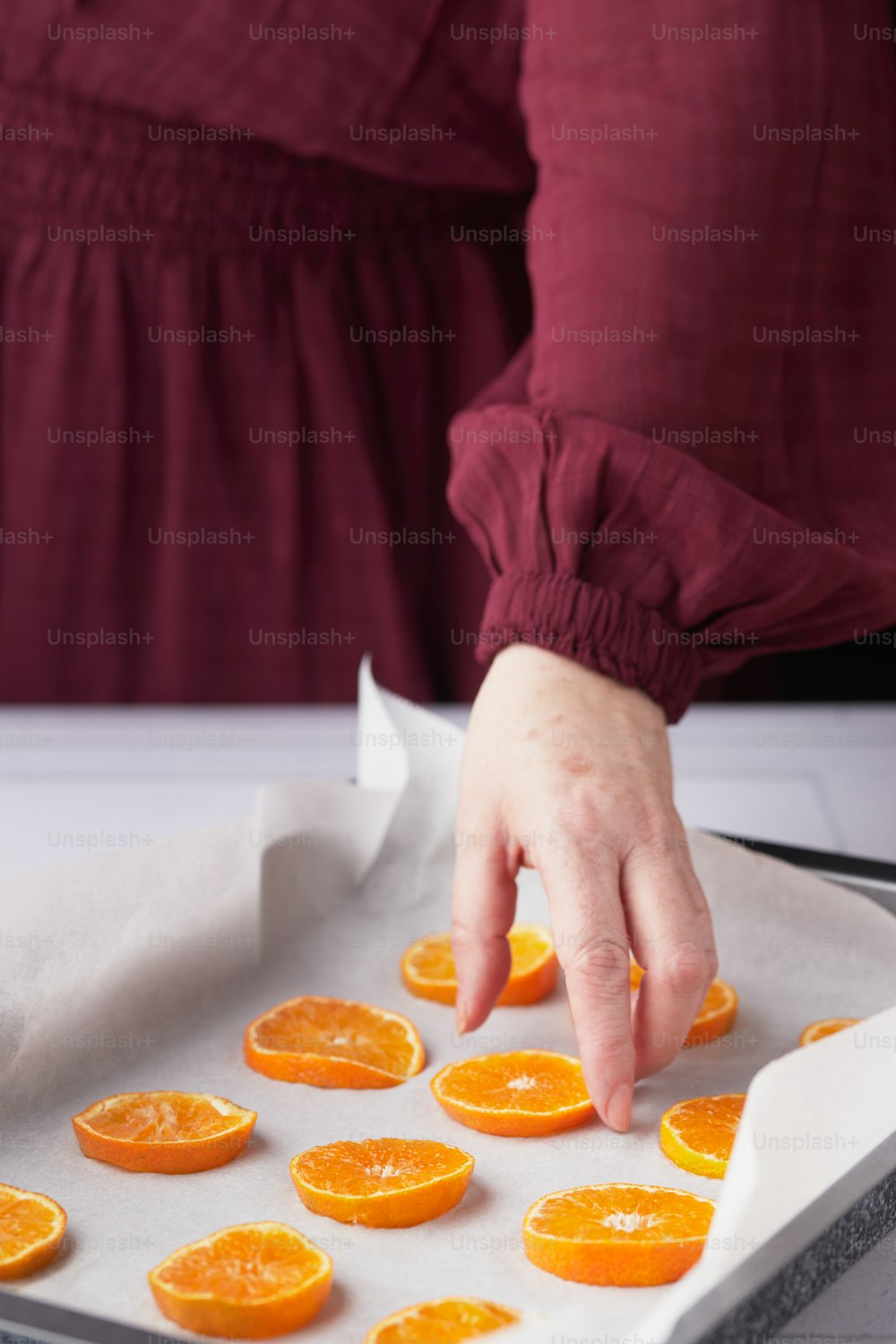 a person cutting oranges