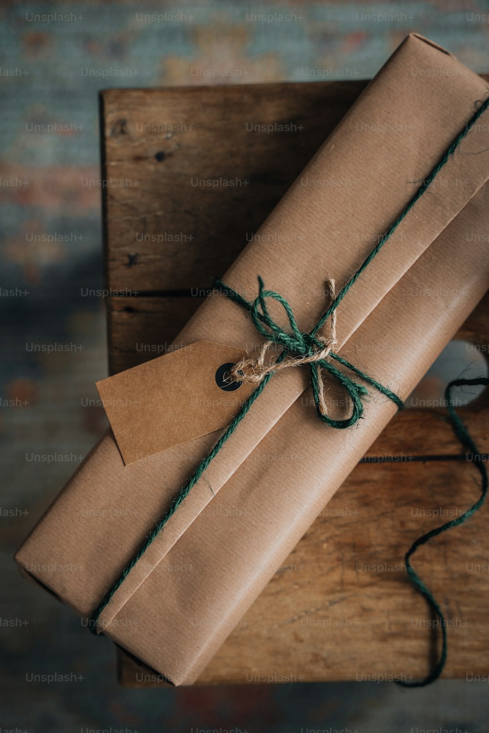 a brown box with a green ribbon