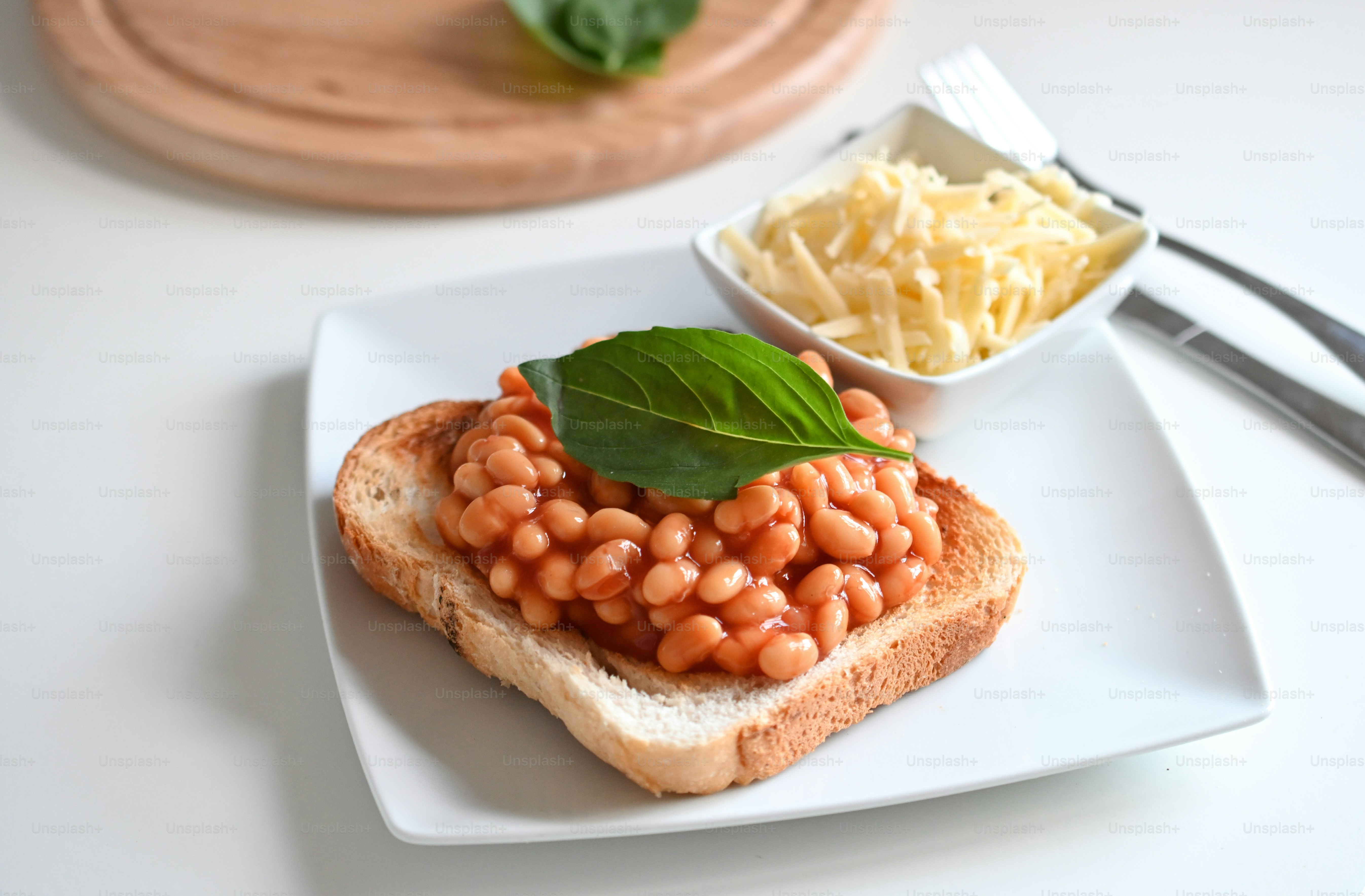 a bowl of beans and a bowl of broth with a leaf on top