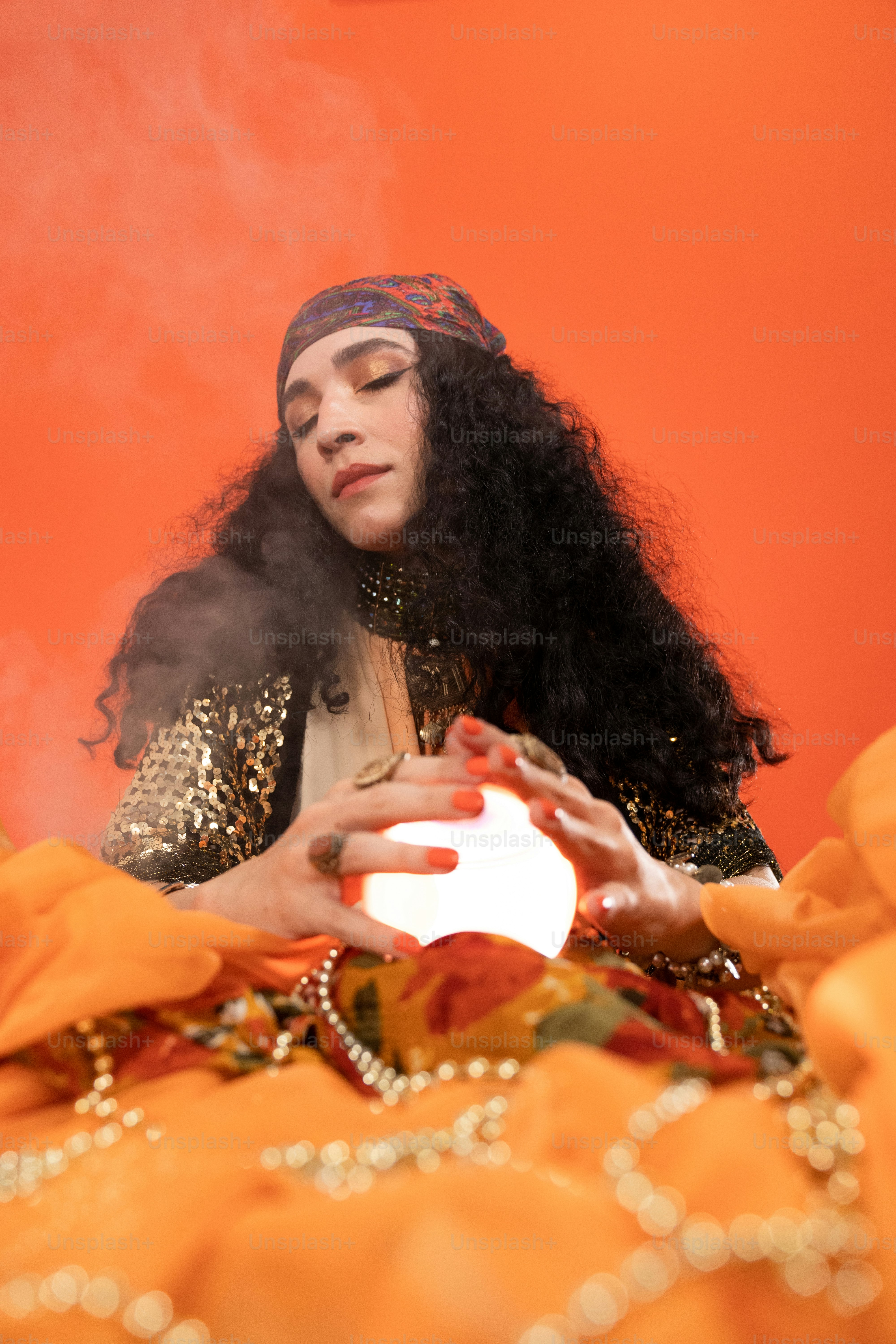 a person in a headdress holding a bouquet of flowers