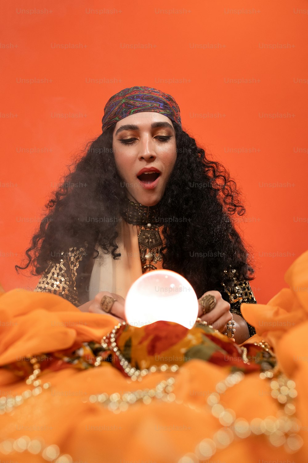 a person wearing a headdress and holding a light bulb
